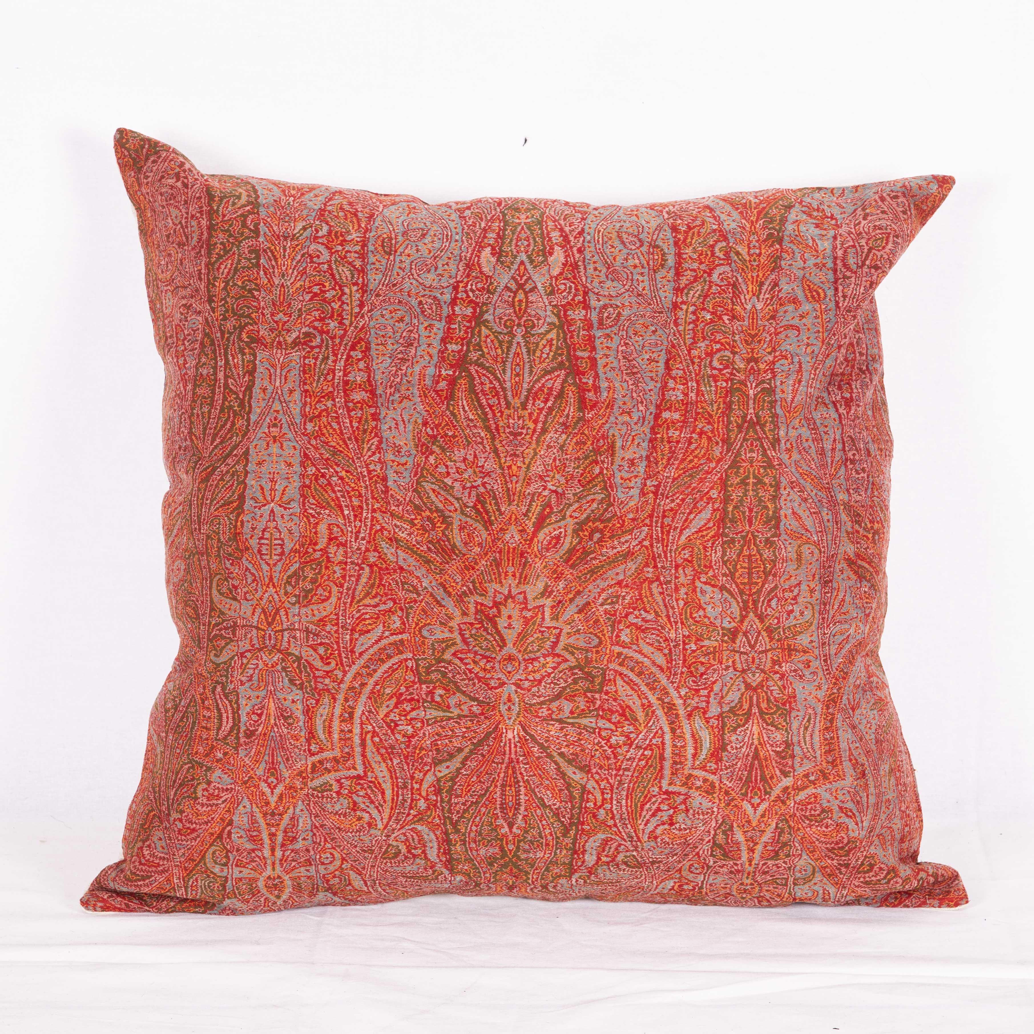 The pillow is made out of an early 19th century paisley shawl. It does not come with an insert but it comes with a bag made to the size and out of cotton to accommodate the filling. The backing is made of linen. Please note: Filling is not provided.