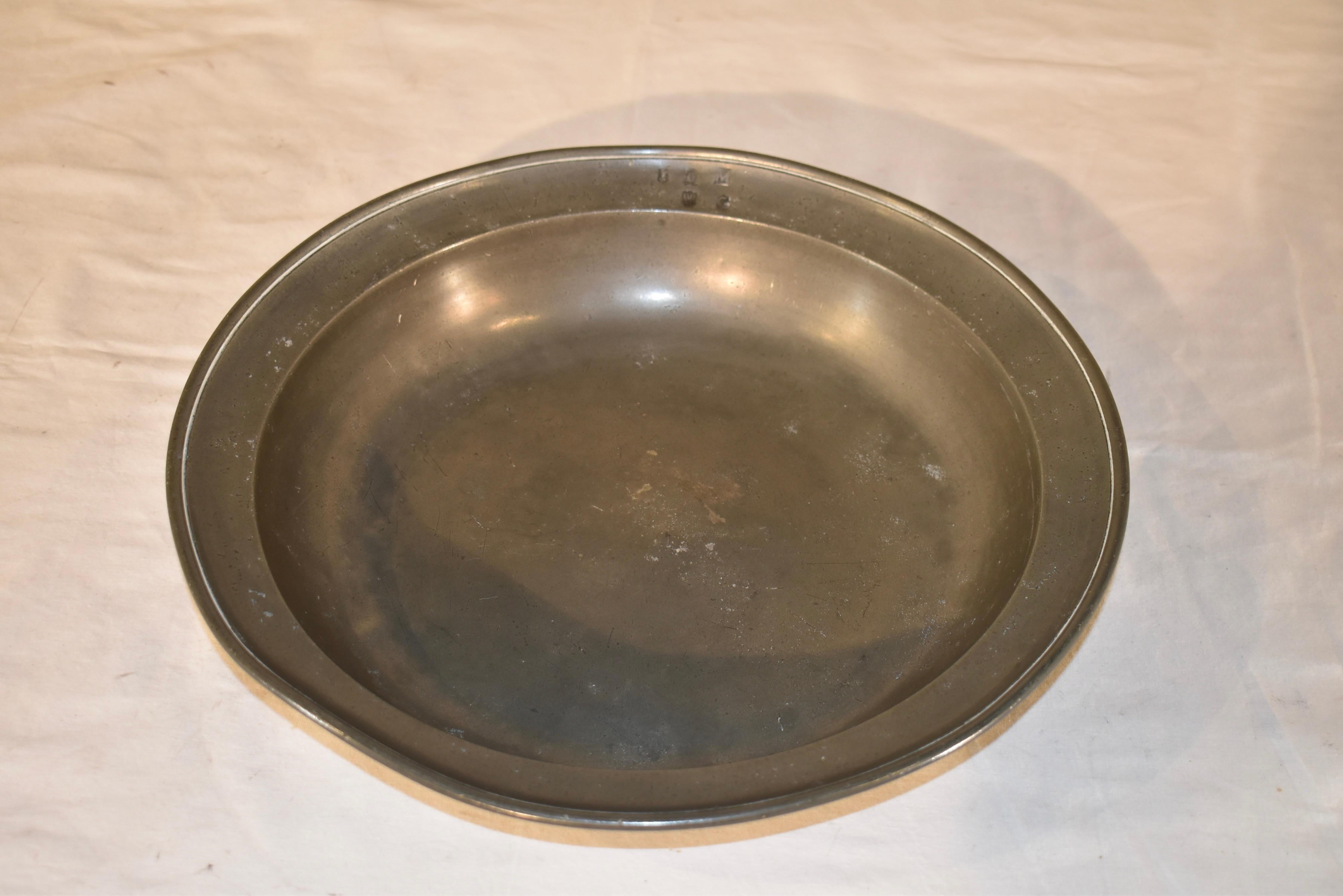 Early 19th century pewter bowl with touch marks on the rim and on the back is the impressed rose and crown with the initials ND.  

This is a wonderful bowl - we have had many pewter chargers over the years, but very few large bowls.  

This would