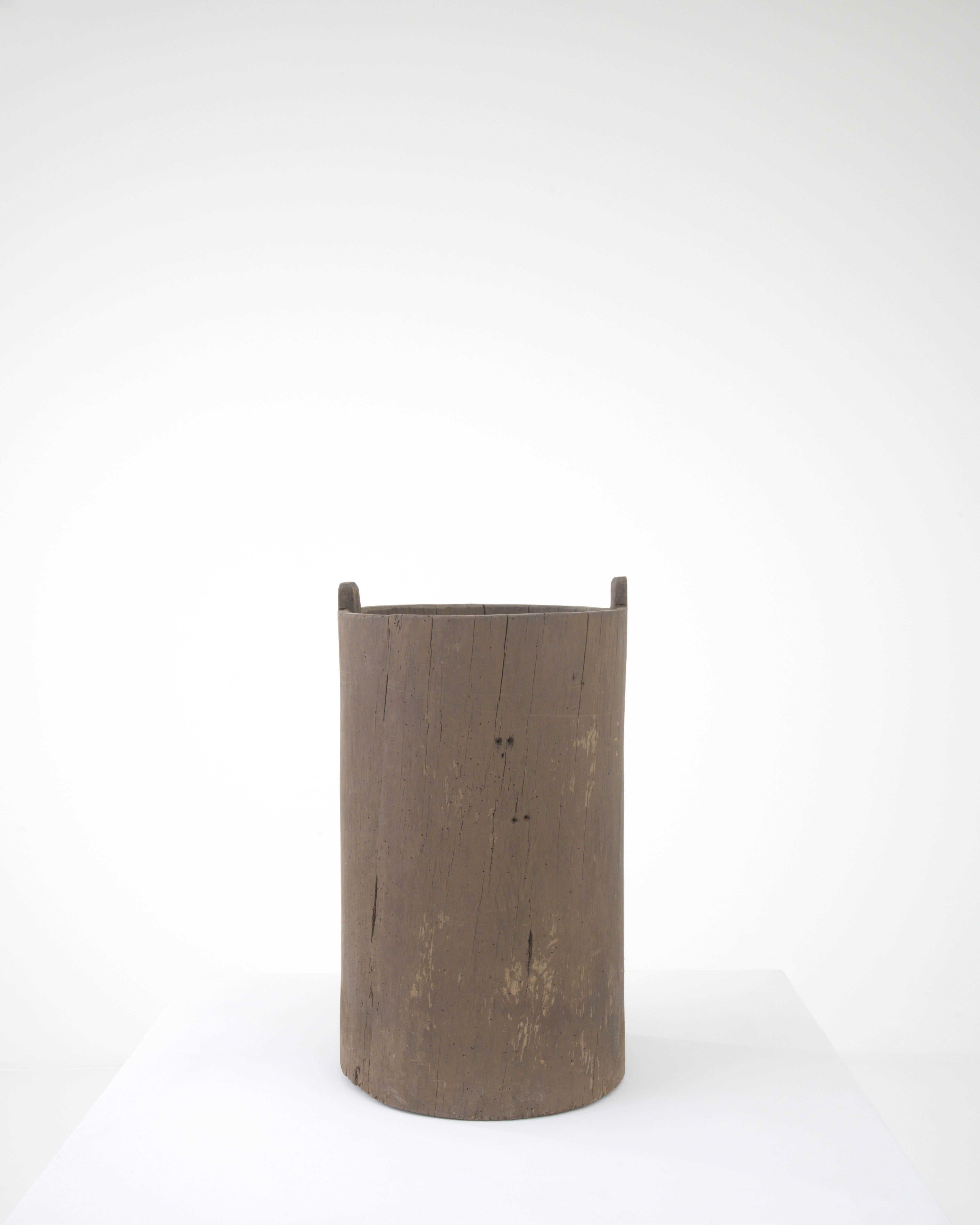 Behold the rustic allure of this 19th Century European Wooden Grain Container, a piece that embodies the simplicity and robustness of rural life. Crafted from solid wood, this container has weathered time, carrying with it a story of harvests past.