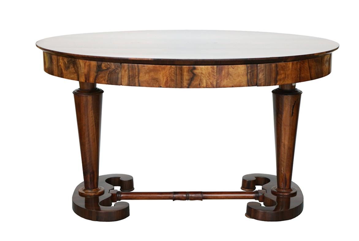 Hello,
This exceptional, early Biedermeier oval writing table was made in Vienna circa 1825.

The table is attributed to the most prolific Viennese cabinet maker during the Biedermeier era, Josef Danhauser. His pieces reflect innovative design and