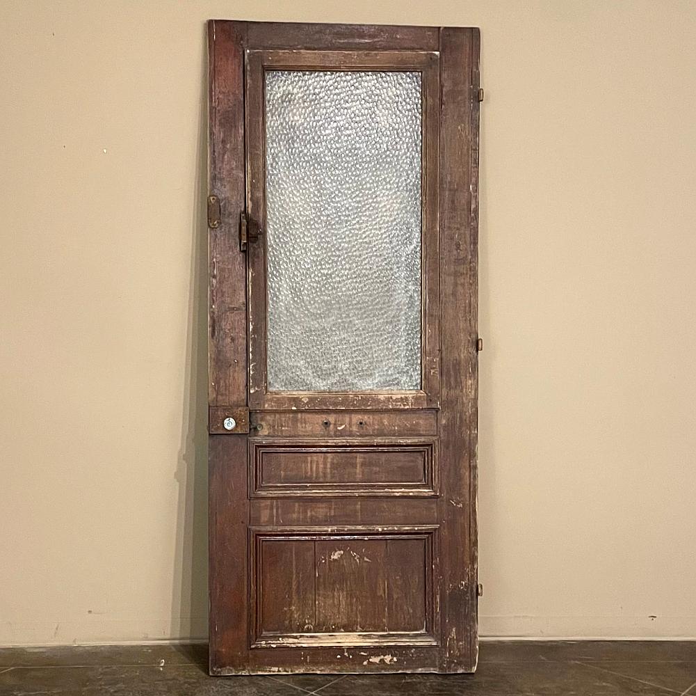 19th Century exterior door with cast iron insert is a product of traditional French craftsmanship, and features solid oak construction designed to last for centuries! The upper framework is inset with a meticulously detailed iron casting, depicting