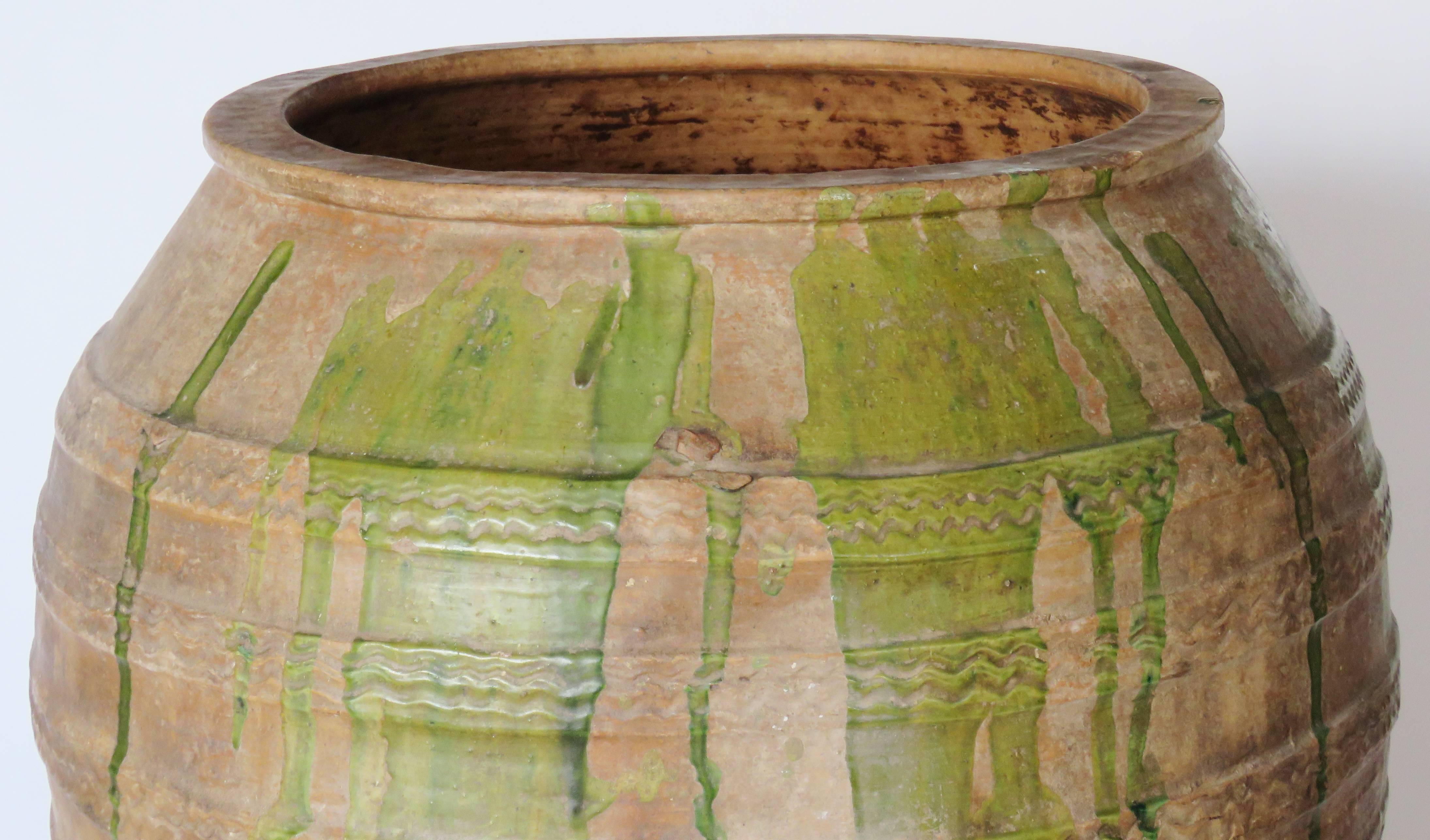 Hand coiled ceramic jar with horizontal ridging zig-zag design and olive green. Beautiful patina. Mouth: 17 1/4