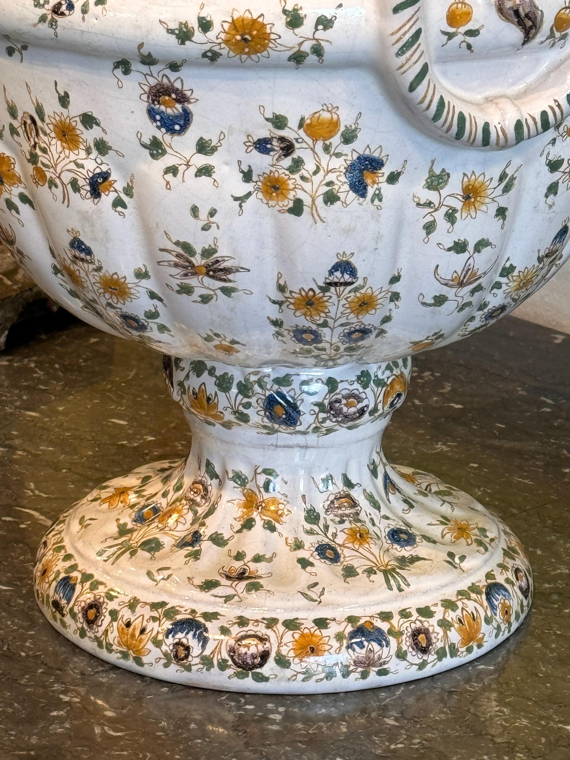 A large scale faience urn with lid. This beautiful piece will add charm and style to anything it sits on.