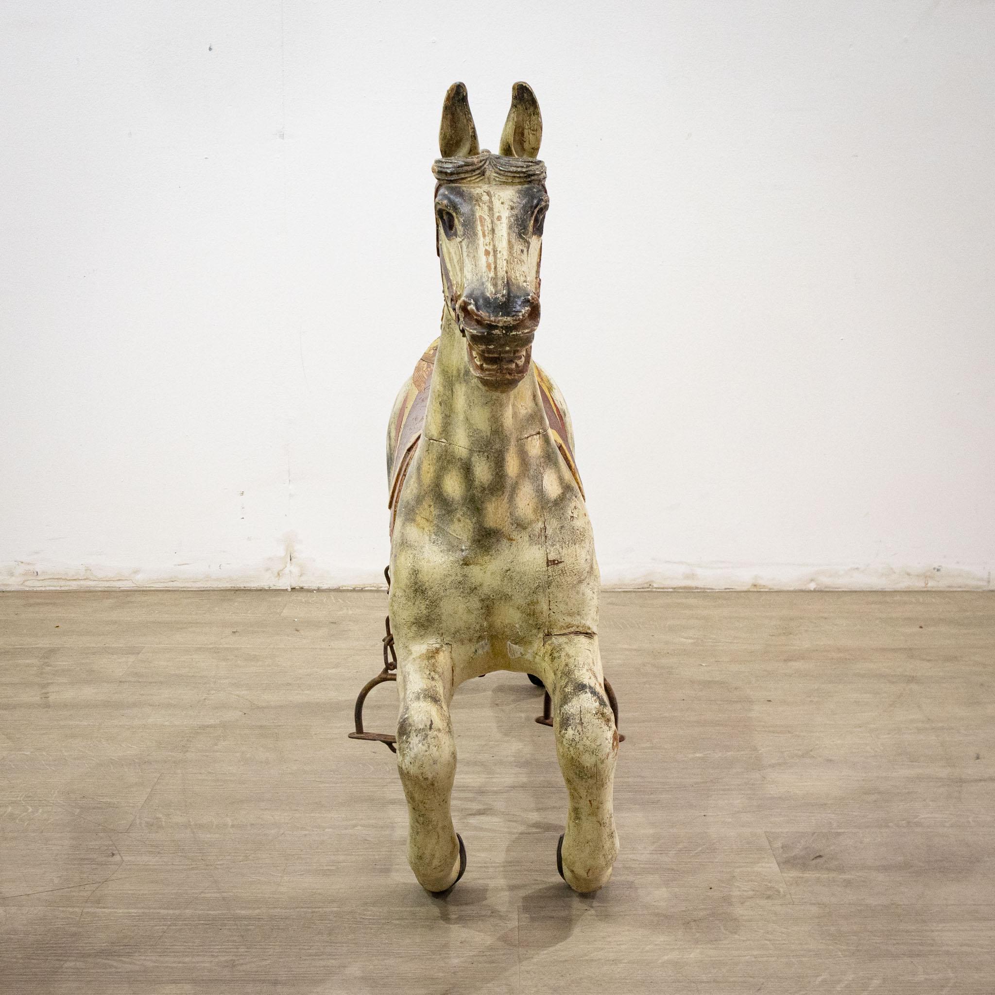 A charming 19th century fairground horse, this would have been attached to a ride, perhaps to a carousel, and is here displayed on a metal stand which has been designed as a rest, although the horse will lift off and stand on four legs without the