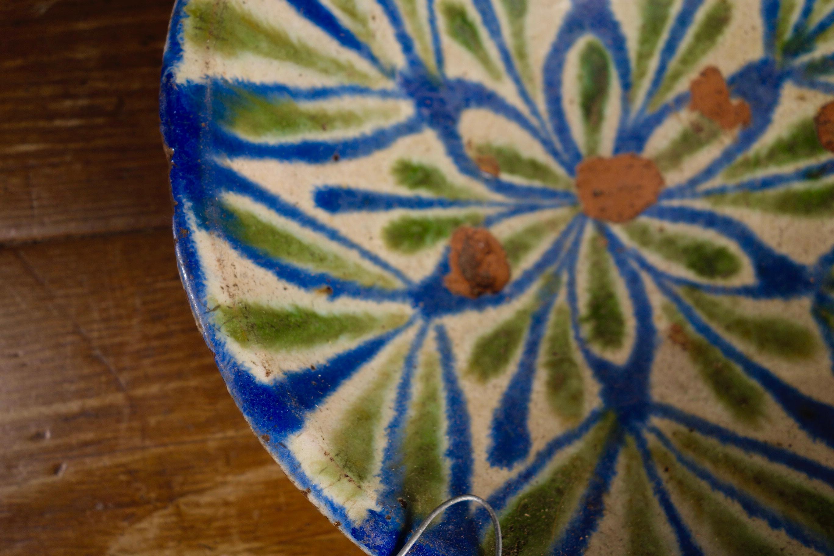 A 19th century Spanish bowl originating from Granada. This bowl has been decorated with green and blue hand painted decorations on top of a milk-white slip glaze.
Measures: 12.5ins diameter
3.5ins high.