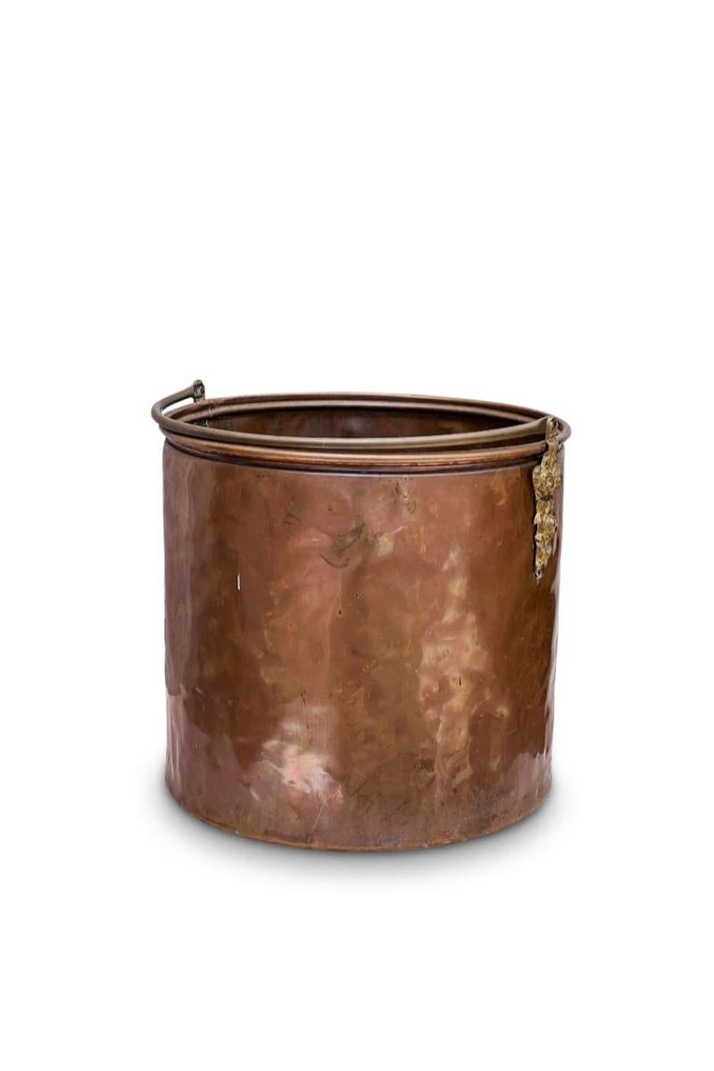 19th Century Farmhouse Copper Antique Cauldron – A sizable handcrafted copper cauldron. Featuring meticulous emblems on handle connections.