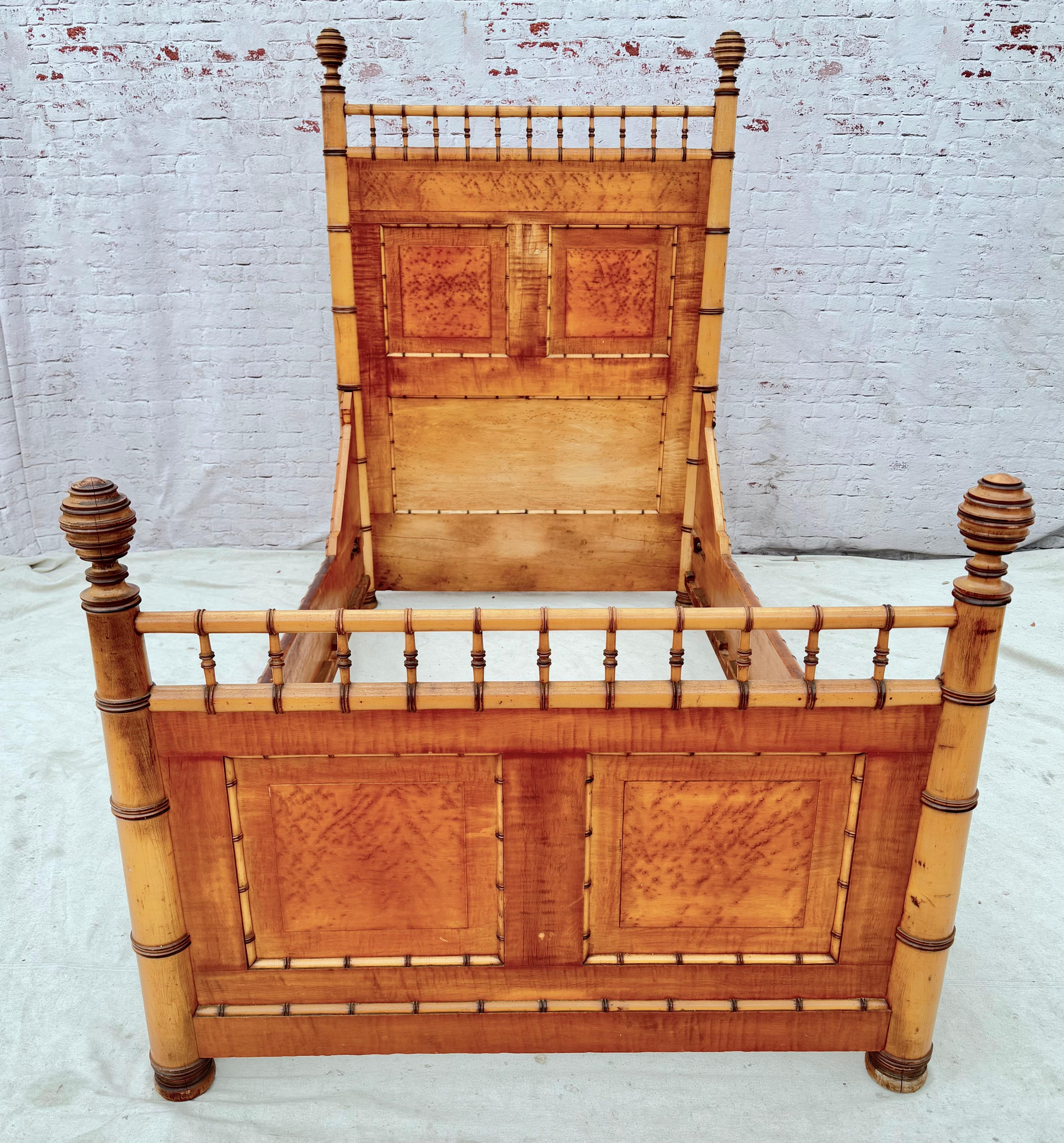 Attributed to R.J. Horner & Co. Aesthetic Movement Faux Bamboo bed. The bed is beautifully designed utilizing various type of maple--birds-eye maple. The faux bamboo spindles are finely crafted as are the elaborately turned finials. The bed appears