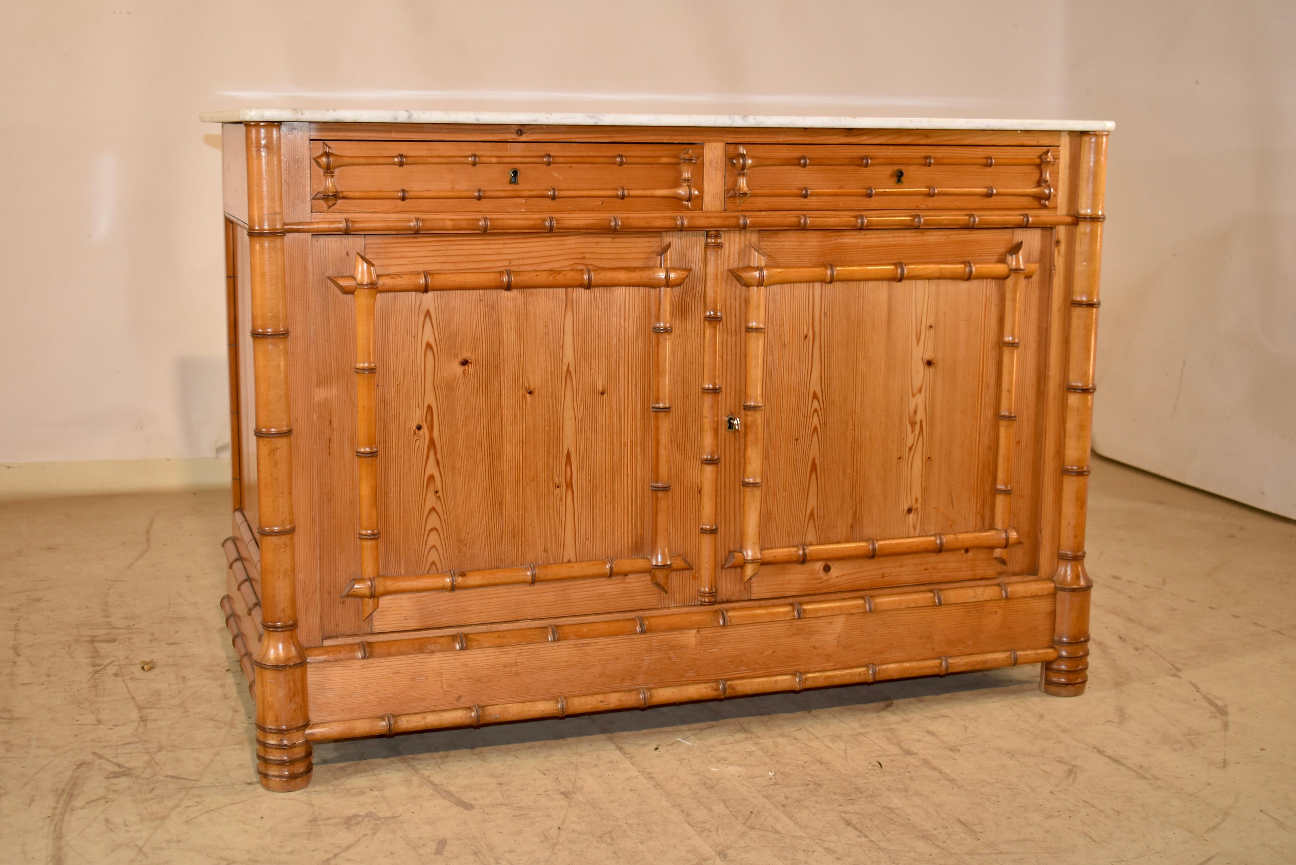 19th century faux bamboo buffet with a Carrara marble top from France.  

The top has a lovely matrix and is a nice neutral color to compliment any decor.  The case has paneled sides, which is a great design feature seen from either side of the