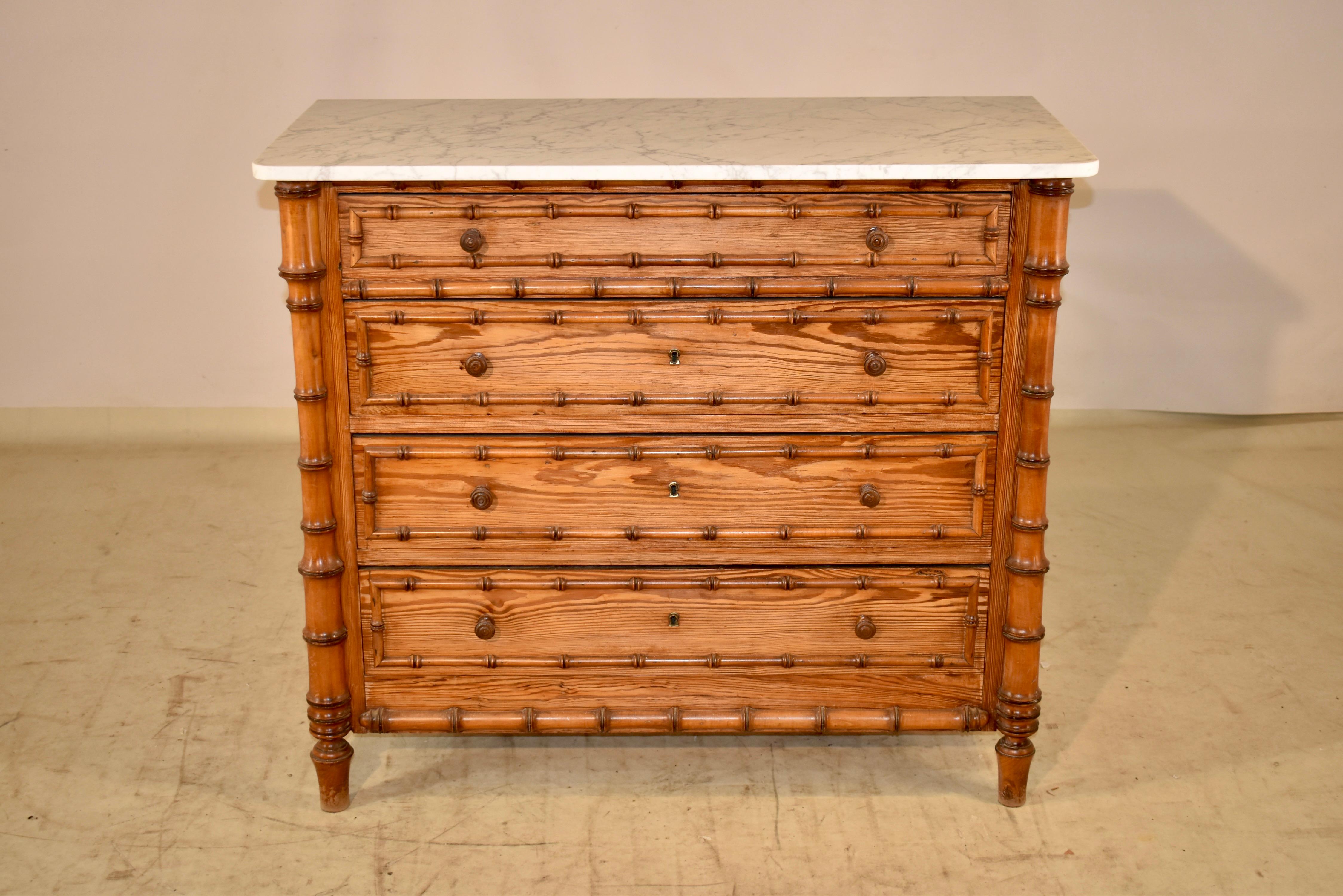 19th century faux bamboo chest of the Art Nouveau period from France. This piece is made from pitch pine, and has lovely graining and a beautiful color. The top is made from Carrara Marble in white with a gorgeous matrix. The chest has simple sides,