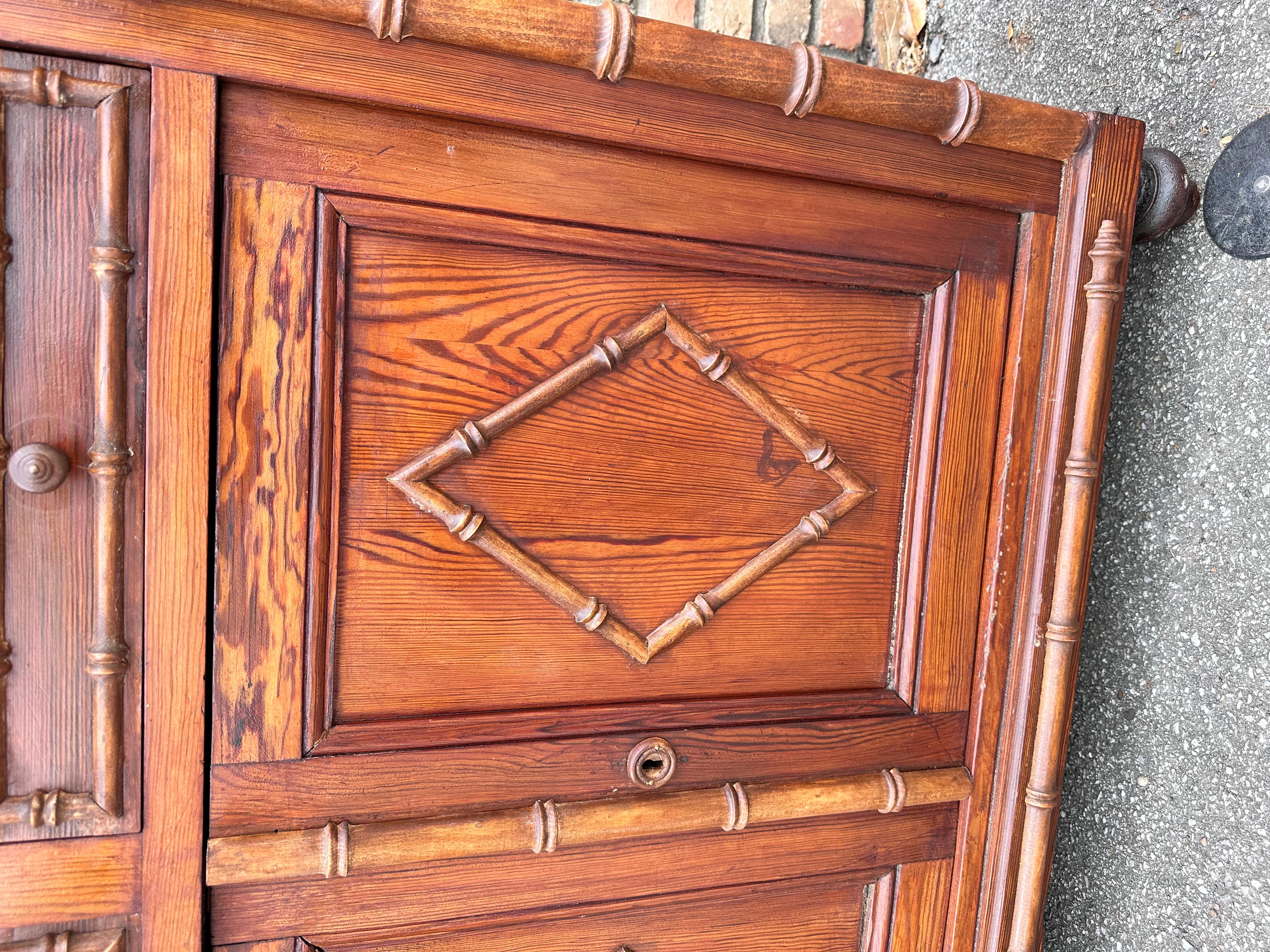 his is a beautiful faux bamboo cupboard! Of French make, this piece has all the typical charm of that style. Lovely glow and patina in the wood, and the hand carved diamond detailing on the drawers and the carved bamboo representation all add to the