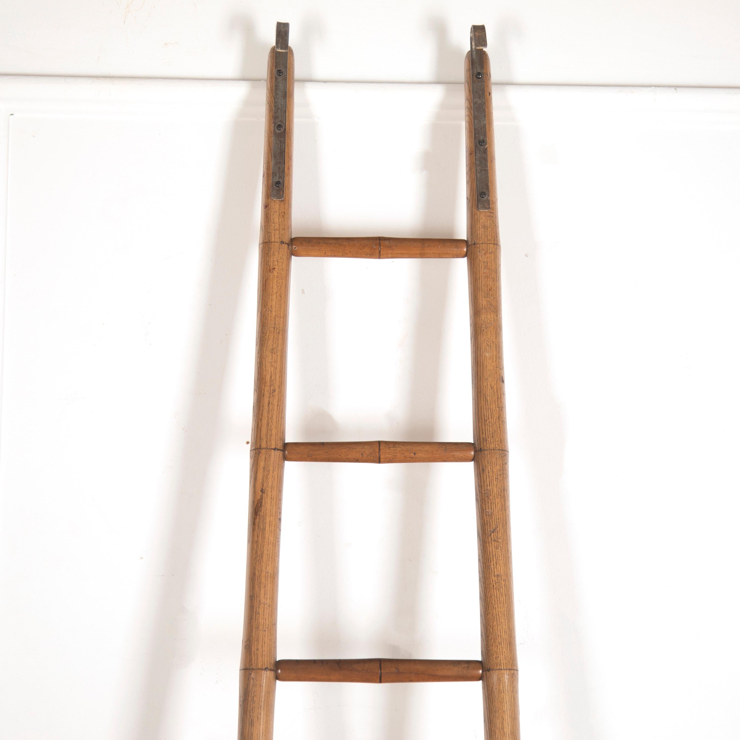 Particularly lovely library ladder, made from ash in the faux bamboo style. 

This ladder is gently tapering, measuring: 40cm wide at the base and 28cm at the top. 

The whole is in very good condition, with original steel hangings from the