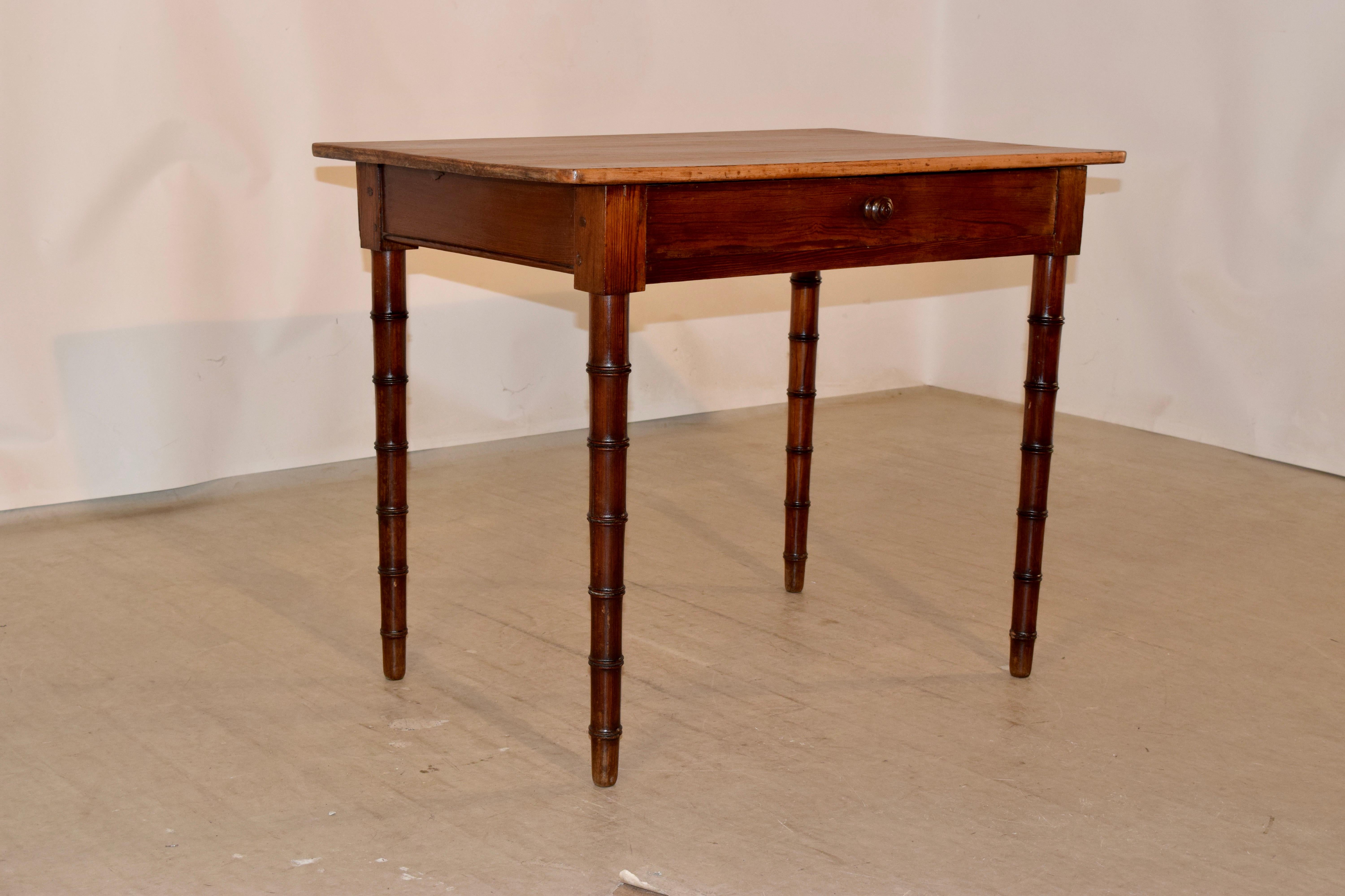 19th century pitch pine side table from England with faux bamboo turnings on the legs. The top is scrubbed and has wonderful patina and character.