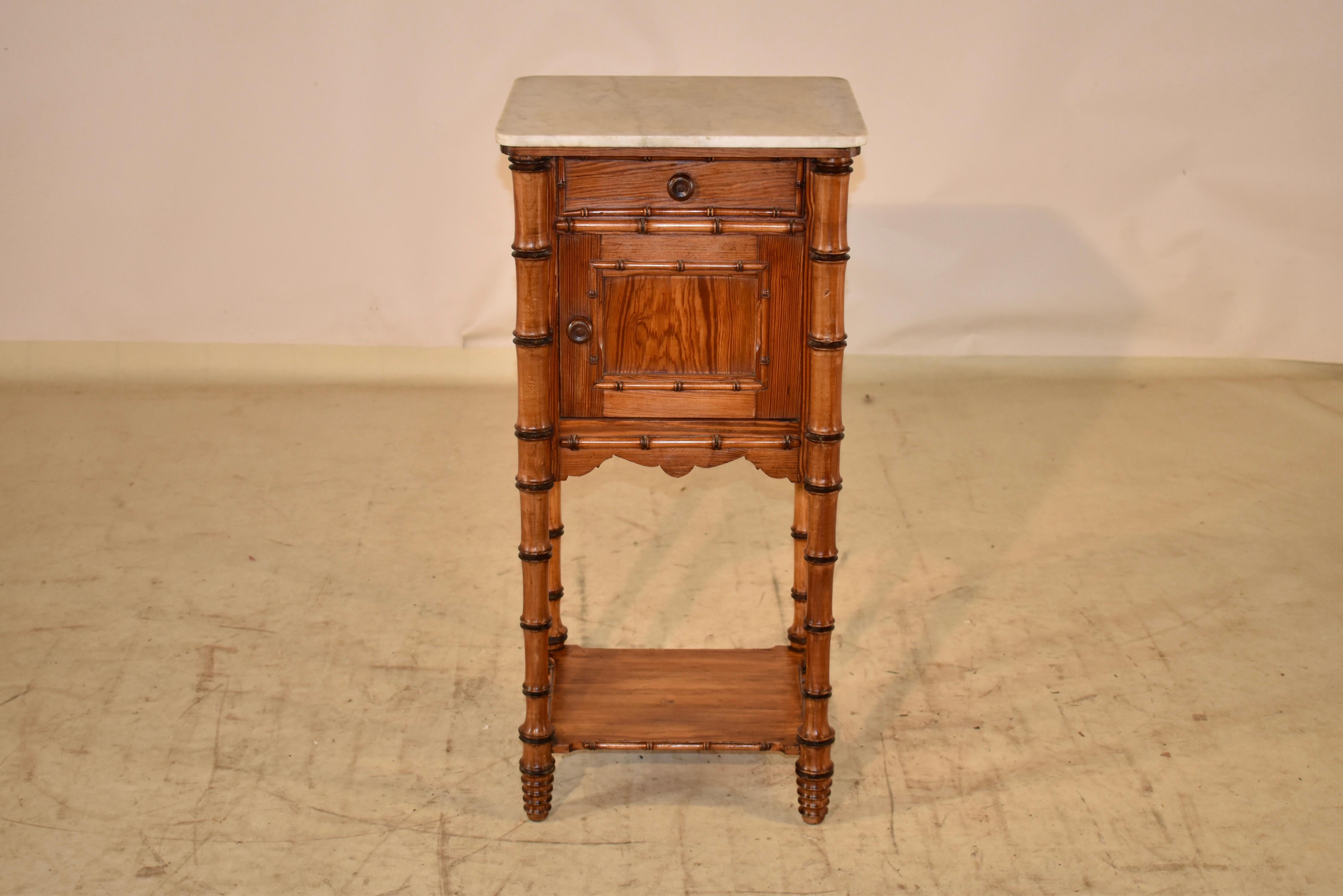 19th century side table in faux bamboo style of the Art Nouveau period in France. The top is made from marble, and sits on a cabinet, which opens to reveal a storage space, which is very useful. The sides are simple and have applied hand turned faux