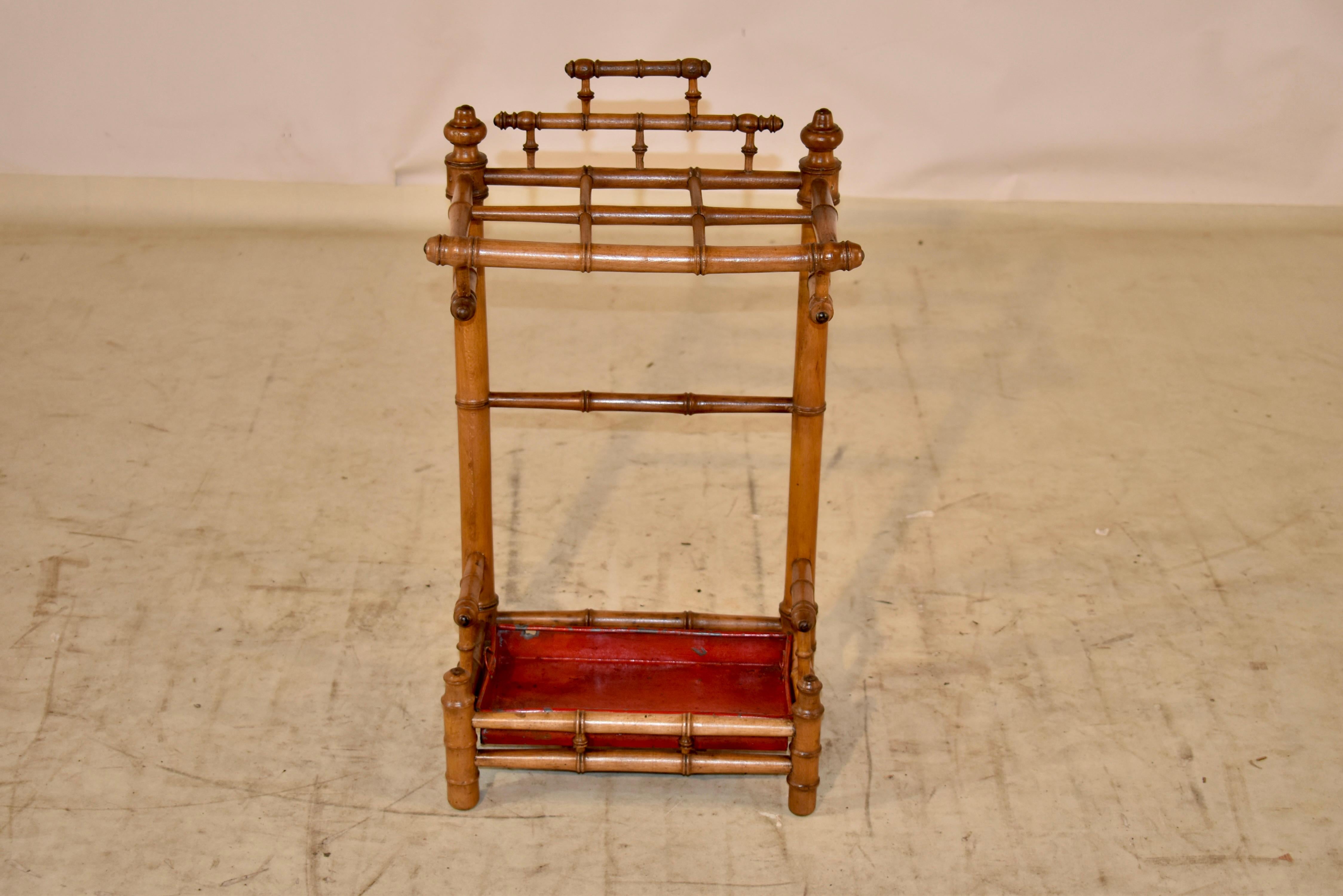 19th century faux bamboo umbrella stand made form Cherry. The design is fantastic and is so unusual! We have never had the pleasure of offering a faux bamboo umbrella stand. This one has six sections for umbrellas or walking sticks, all with lovely