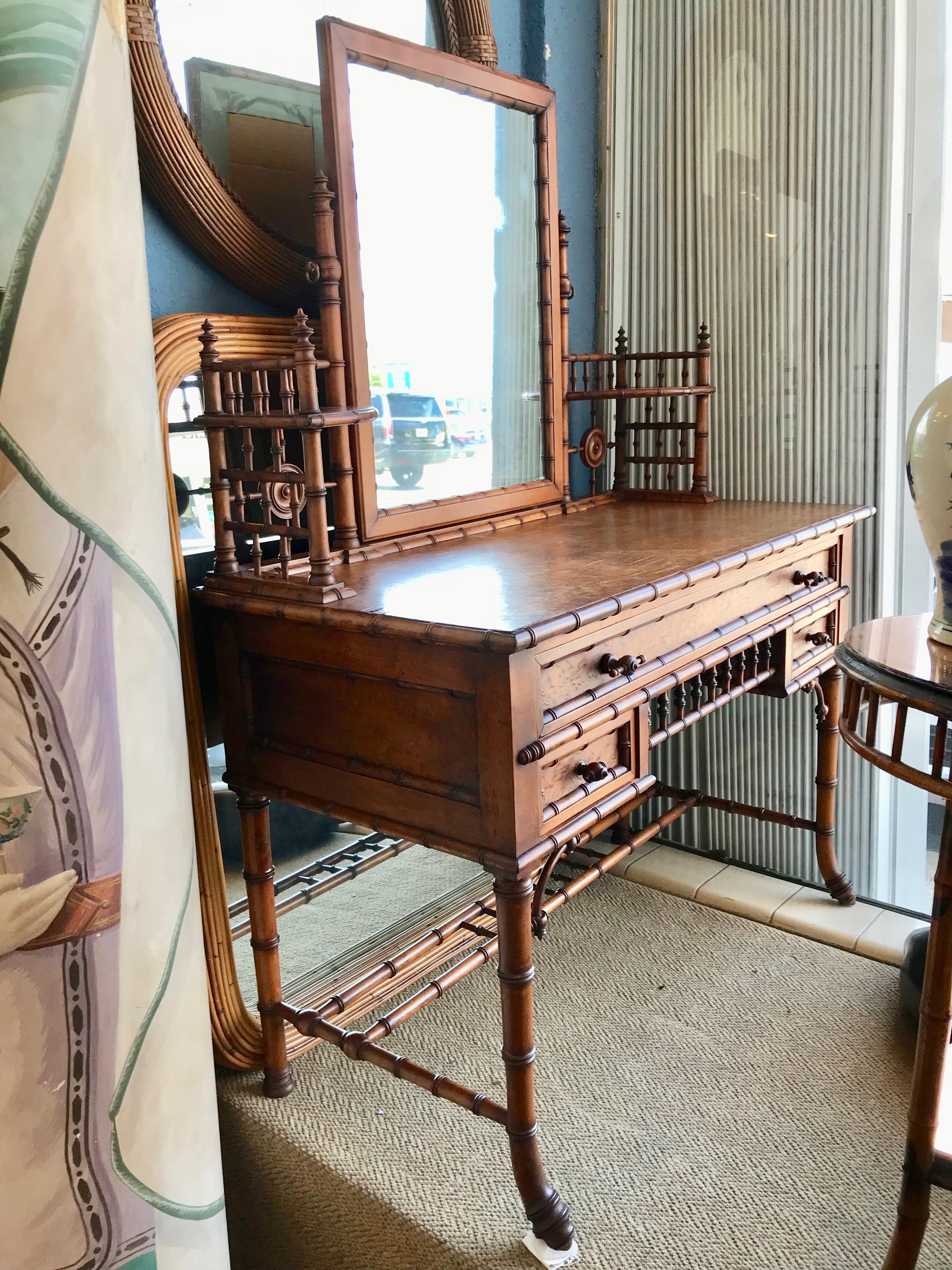 A fine aesthetic movement example. A charming and eye catching vanity
fashioned with elaborate galleries and simulated bamboo accents, including root feet.
The carvings are sharp and nicely detailed. The finish is maple.