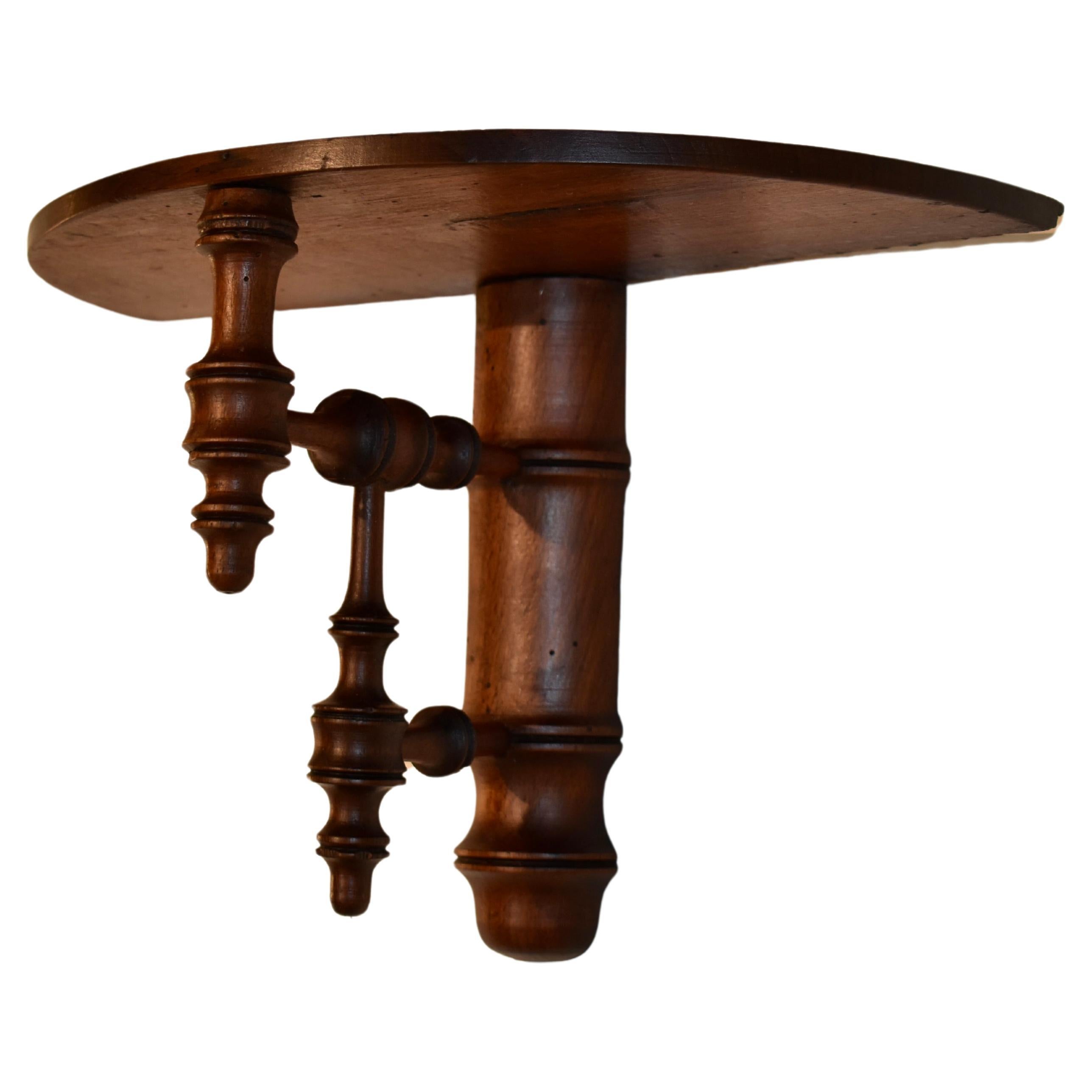 Late 19th century faux bamboo wall bracket shelf.  The top is a generously sized semi-circle, supported on a base of hand turned faux bamboo and expertly turned pieces.  This is a lovely shelf and would look great in any room of the house or office.