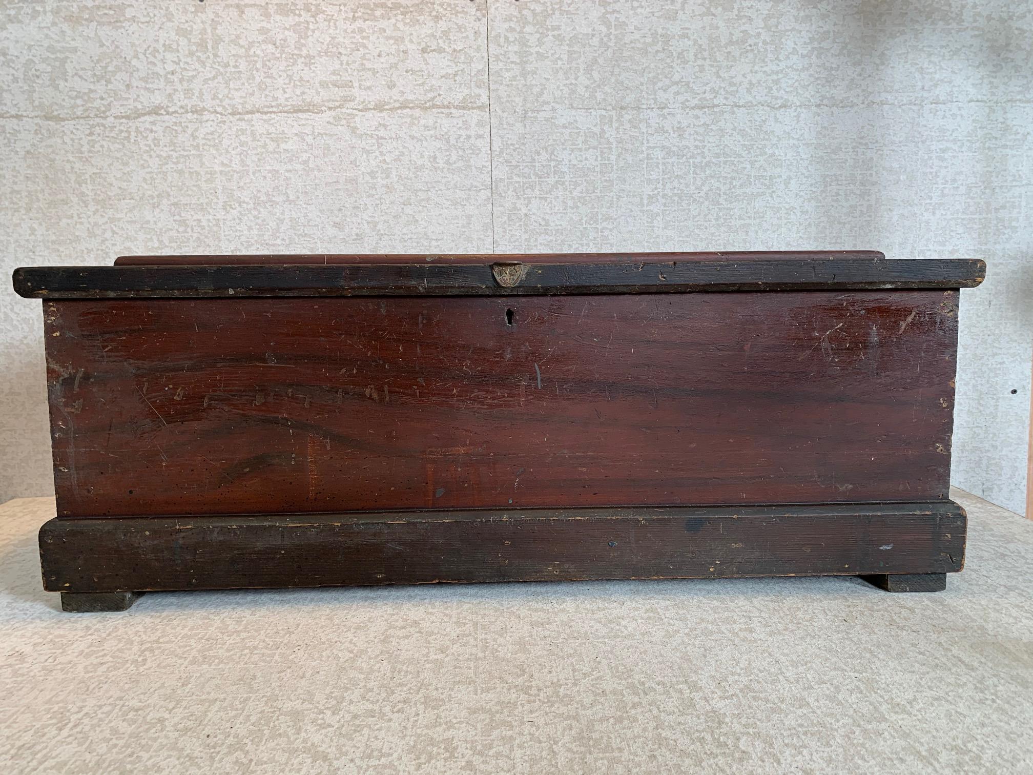 This Classic carpenter's tool box has a removable sliding shelf and sports original grain-paint and hardware including a bronze Eastlake finger lift and heavy cast iron bails and backplates. The lock in missing. 
circa 1890.