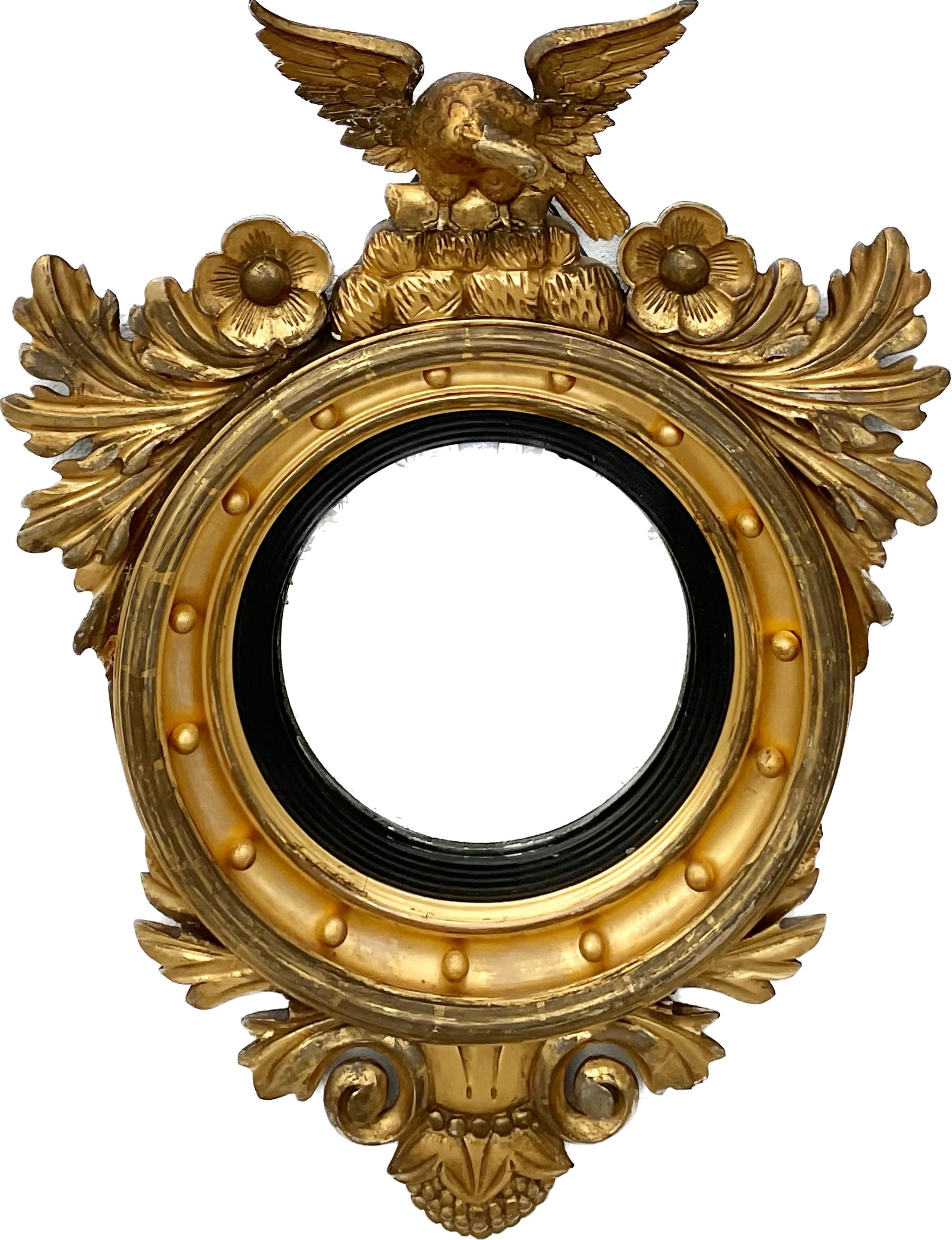 19th Century Federal Eagle Round Gilt Wood Frame Mirror. The frame consists of 15 round balls framed by garlands and flowers with an eagle with wide spread wings atop of frame. 