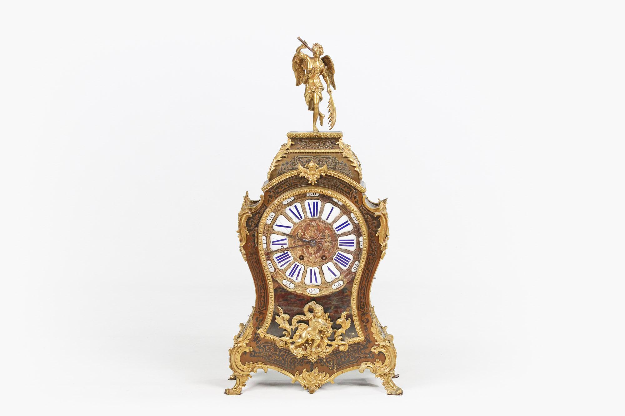 19th century figural mantle clock in the Rocaille manner, the boulle work case of waisted design decorated with finely cast ormolu mounts to the front and sides depicting a putto bearing flowers with C and S scrolls, foliate and acanthus leaf,