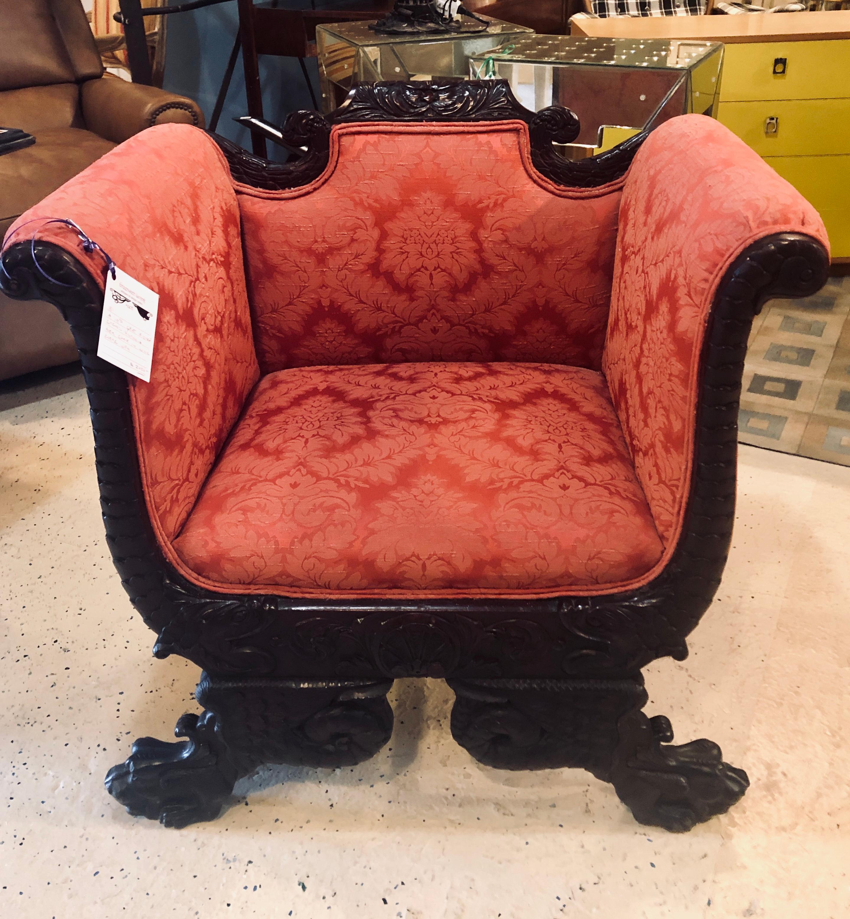 19th century figure carved Victorian armchair in lovely rose colored upholstery. This early finely carved arm or lounge office chair is simply spectacular having figural feet with full tails.