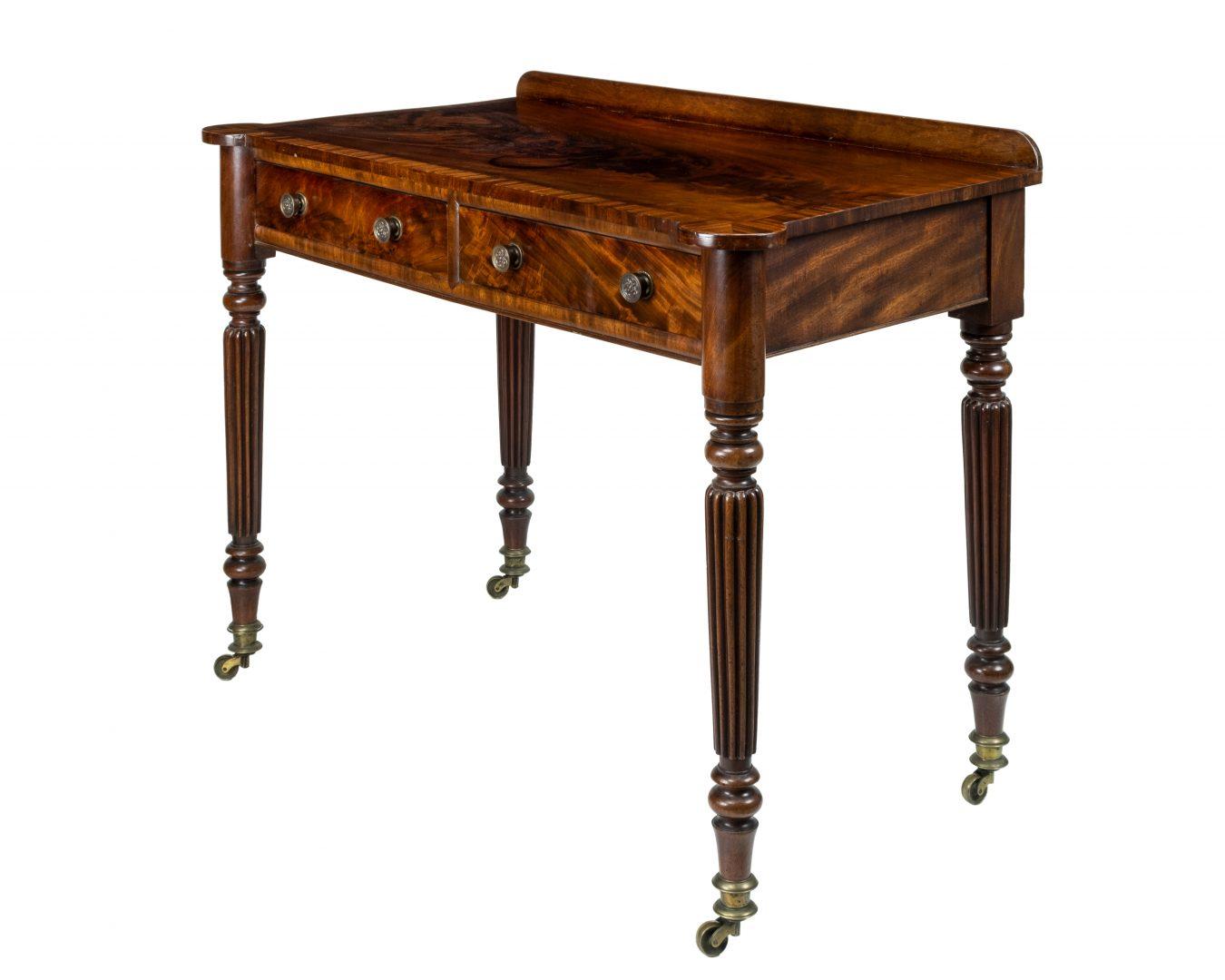 A 19th century figured mahogany side table attributed to Gillows, the cross banded top over two drawers on turned and reeeded tapering legs to brass caps and castors.

Gillows of Lancaster and London, also known as Gillow & Co., was an English