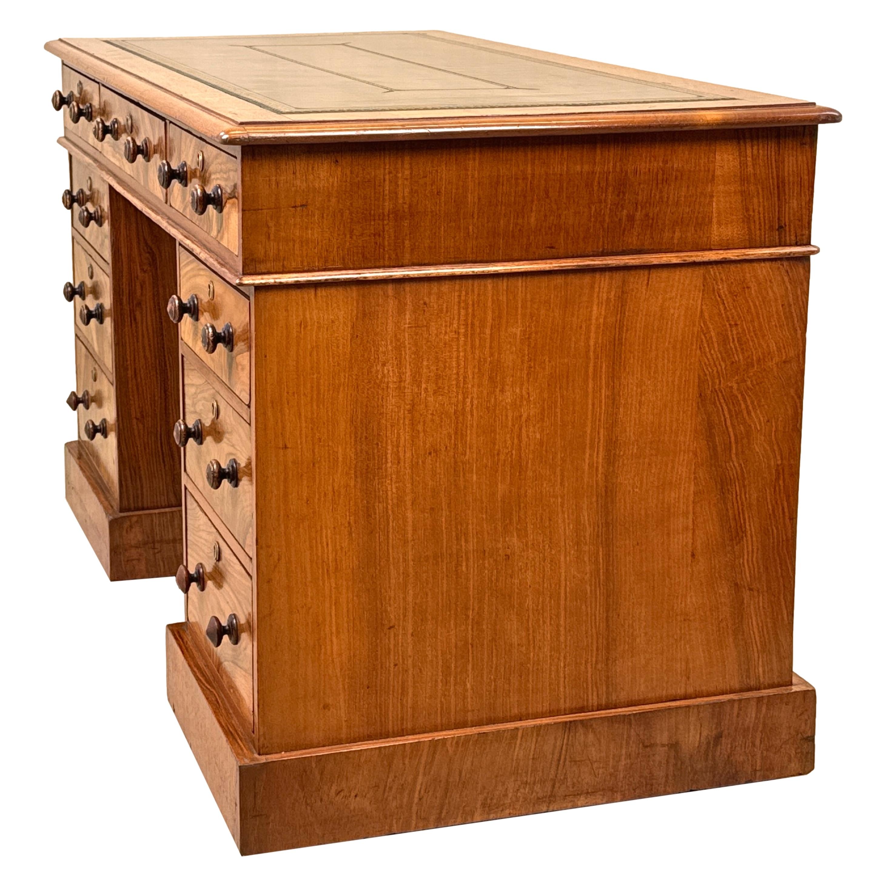 A Very Good Quality Mid 19th Century Walnut Pedestal Desk, Of Practical Proportions, Having Attractive Gilt Tooled Leather Top, Over Nine Extremely Well Figured Drawers With Mostly Original Turned Wooden Knobs, Raised On Original Plinth Base And