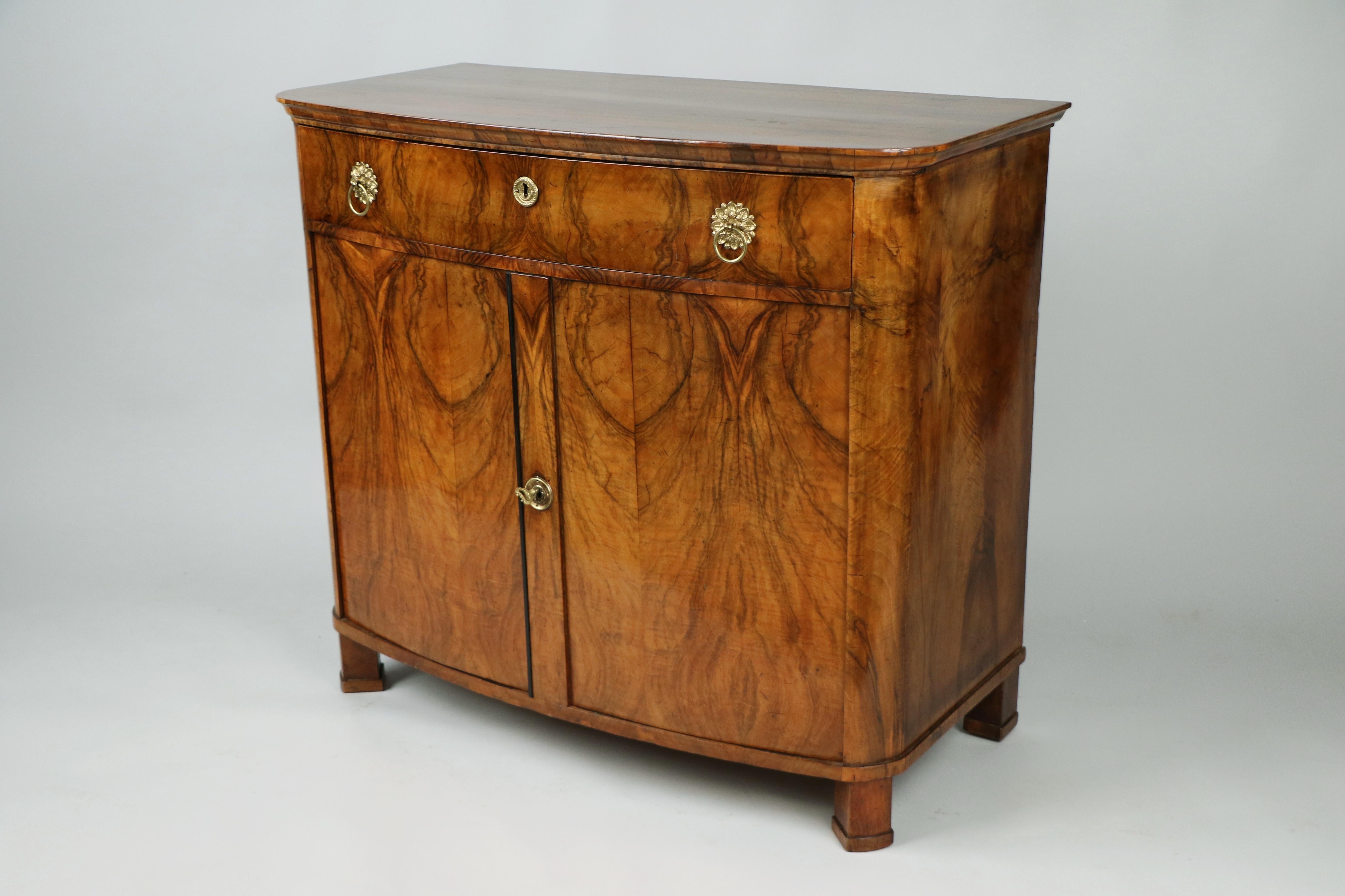 We are pleased to offer this exceptional and authentic Viennese Biedermeier walnut trumeau commode, crafted around 1825, a refined example that perfectly represents the essence of Biedermeier design—celebrated for its sophisticated proportions,
