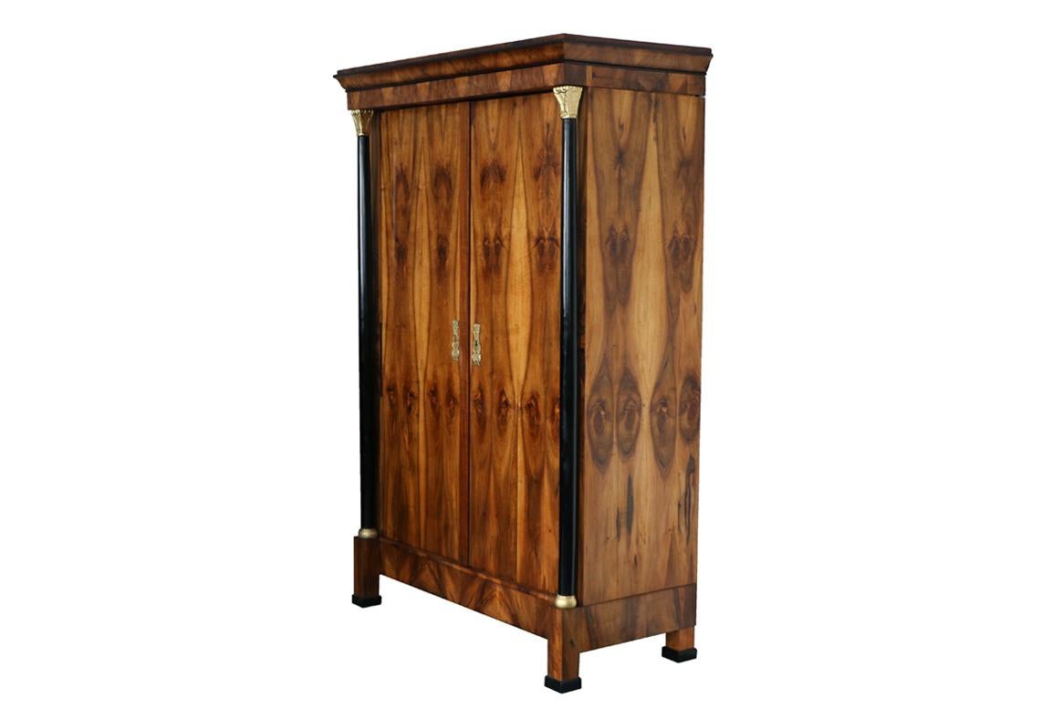 Hello,
This exceptional Biedermeier walnut armoire was made in Vienna circa 1820-25.

Viennese Biedermeier is distinguished by their sophisticated proportions, rare and refined design and excellent craftsmanship and continue to have a great