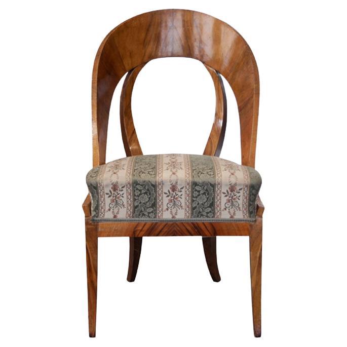 Hello,
This rare and elegant Biedermeier walnut chair was made in Vienna circa 1825.

Viennese Biedermeier pieces are distinguished by their sophisticated proportions, rare and refined design, excellent craftsmanship and continue to have a great