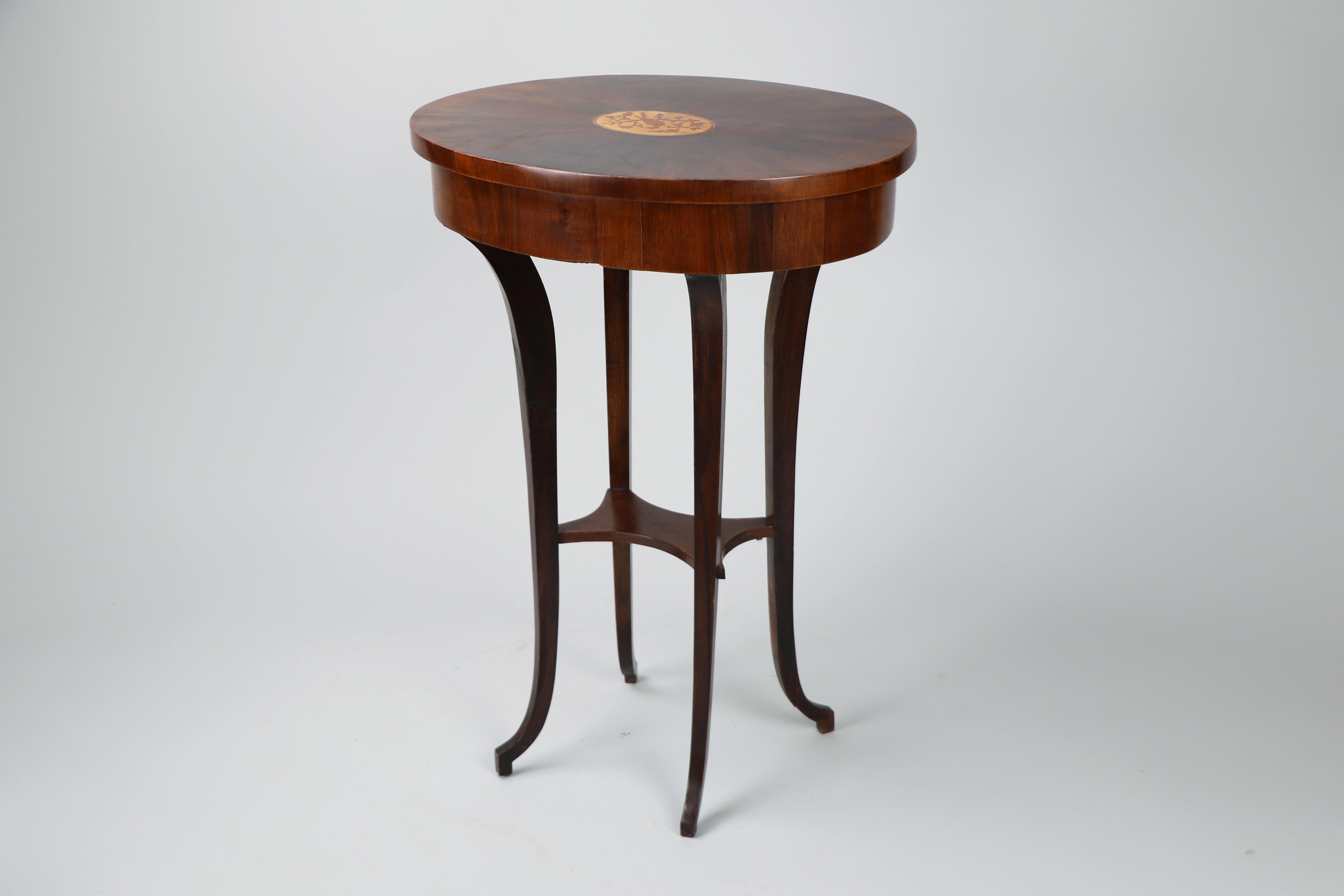 Cette exquise et rare table d'appoint en noyer Biedermeier, légèrement ovale, fabriquée vers 1825 à Vienne, illustre l'élégance et l'attrait intemporel de l'artisanat viennois. Les pièces Biedermeier sont célébrées pour leurs proportions raffinées,