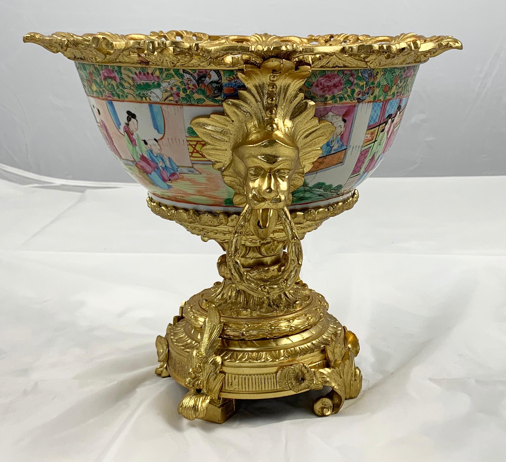 A fine Cantonese Famille rose and ormolu-mounted two handled Bowl, late 19th century. Decorated with figures in room scenes. The heavy ornate mounts cast with Classic motifs husks and foliage. On a massive base with knurled feet.