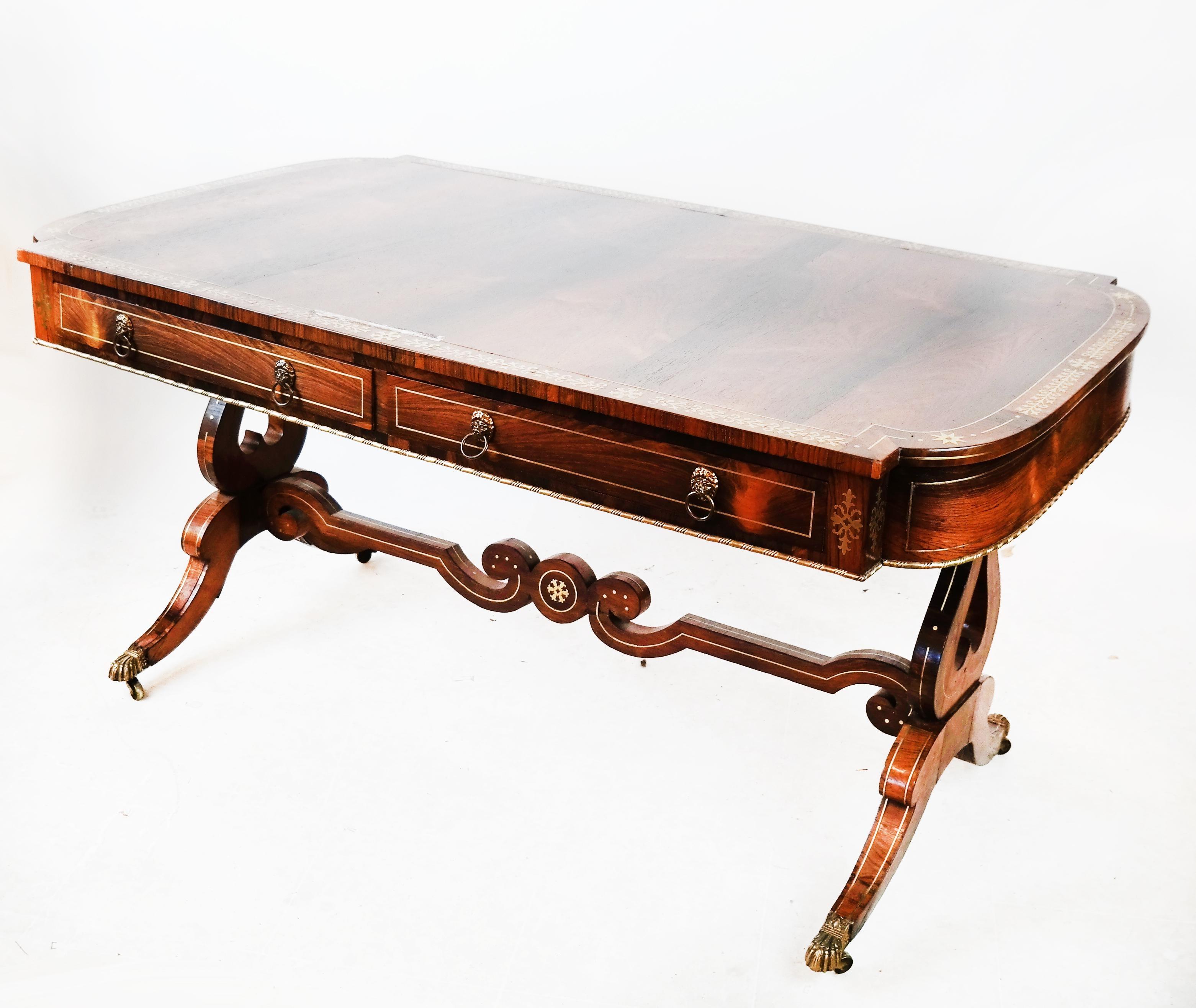 A very fine 19th century English Regency rosewood desk with brass inlay.