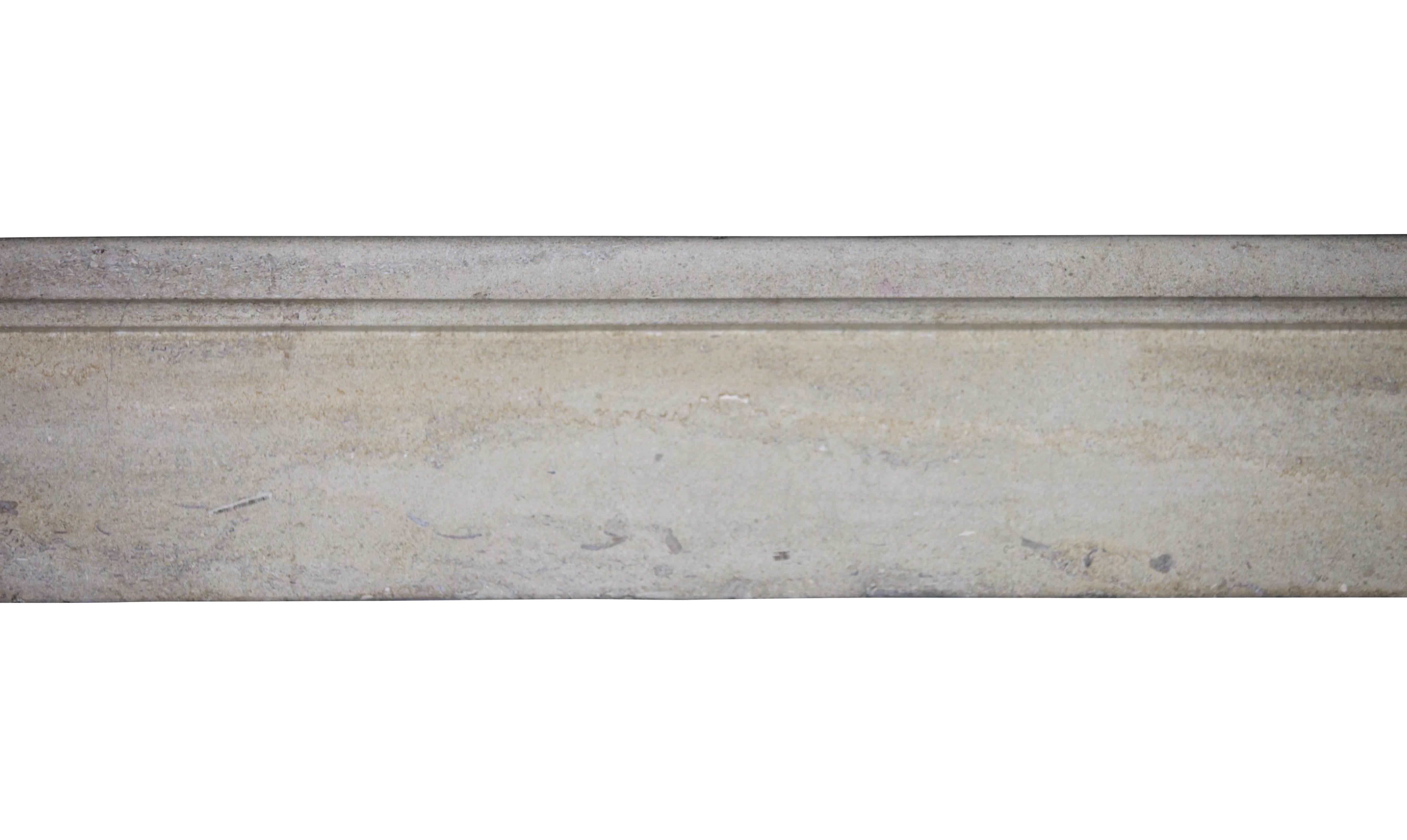 This is a nice 19th century French plain beige limestone teint original antique fireplace mantle in a hard limestone. It could work in a timeless minimalistic interior. In the images you will also see the smooth ancient surfaces reflecting the light