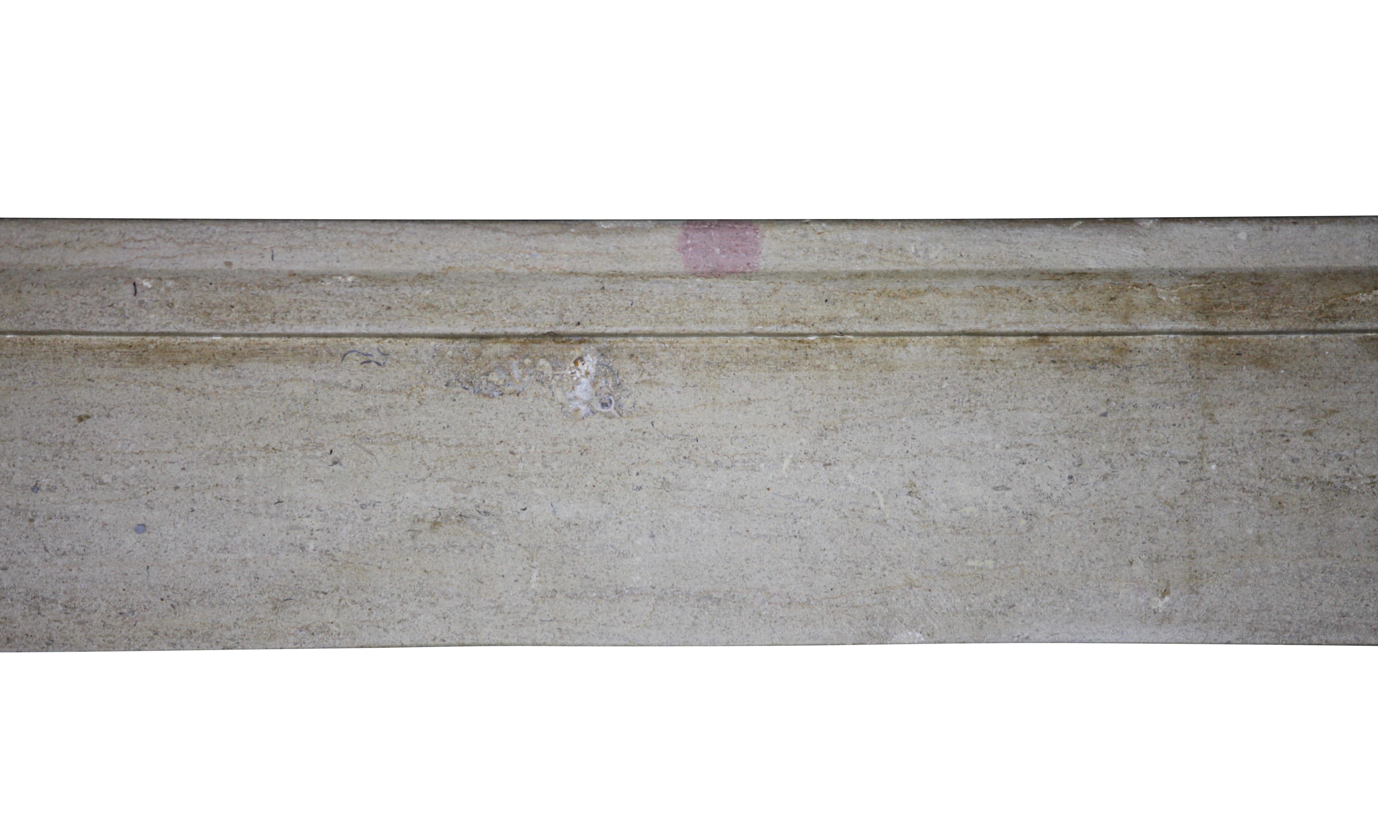 This is a stylish 19th century petite, small, beige French country Bourguignonne marble hard limestone original antique fireplace surround. This piece has been waxed and can fit different interior styles. It reflects the light of the