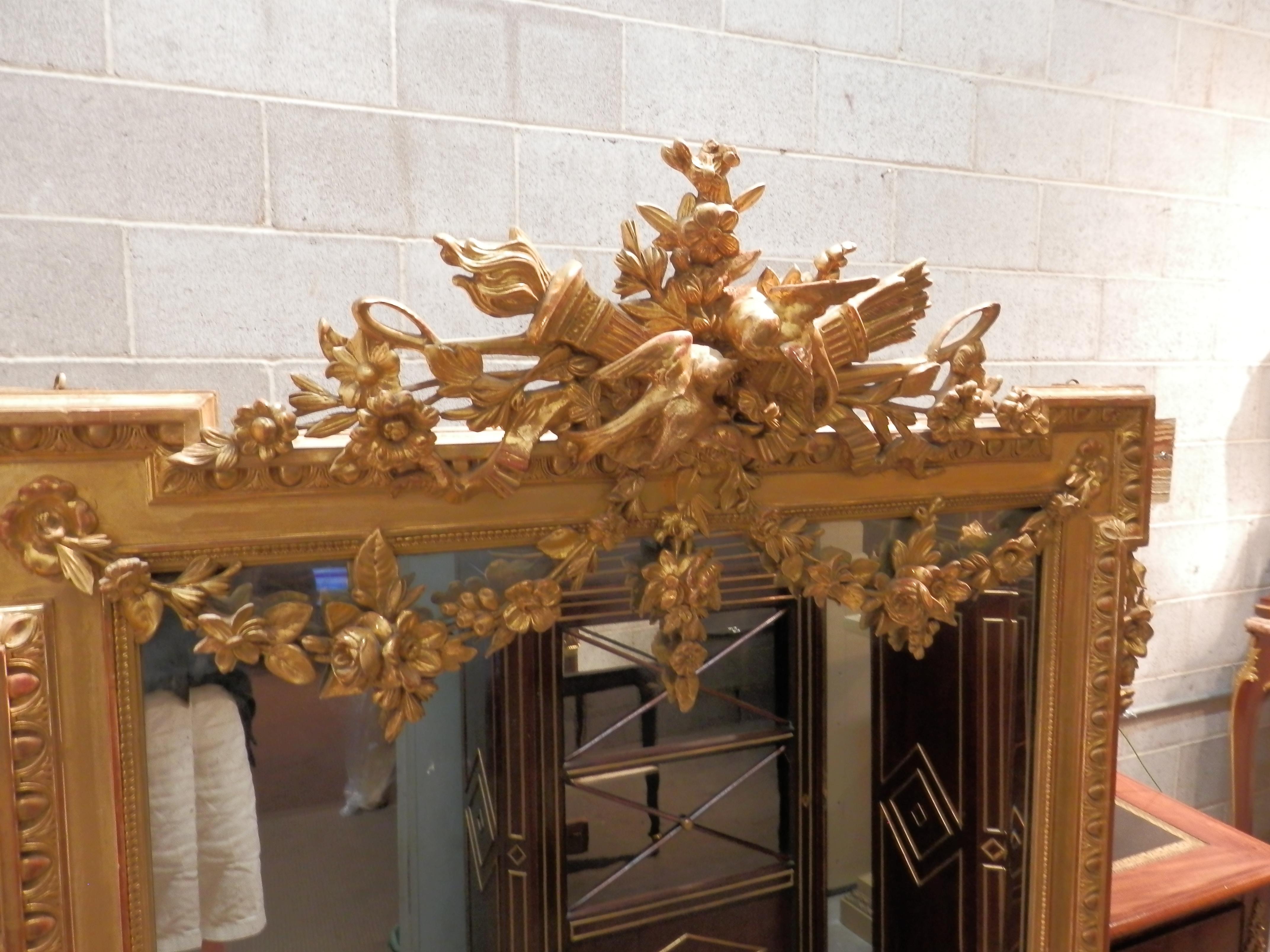 A fine French Louis XVI French gilt carved wall mirror. Finely carved love birds and flowers with Louis XVI details referred to as a wedding mirror.