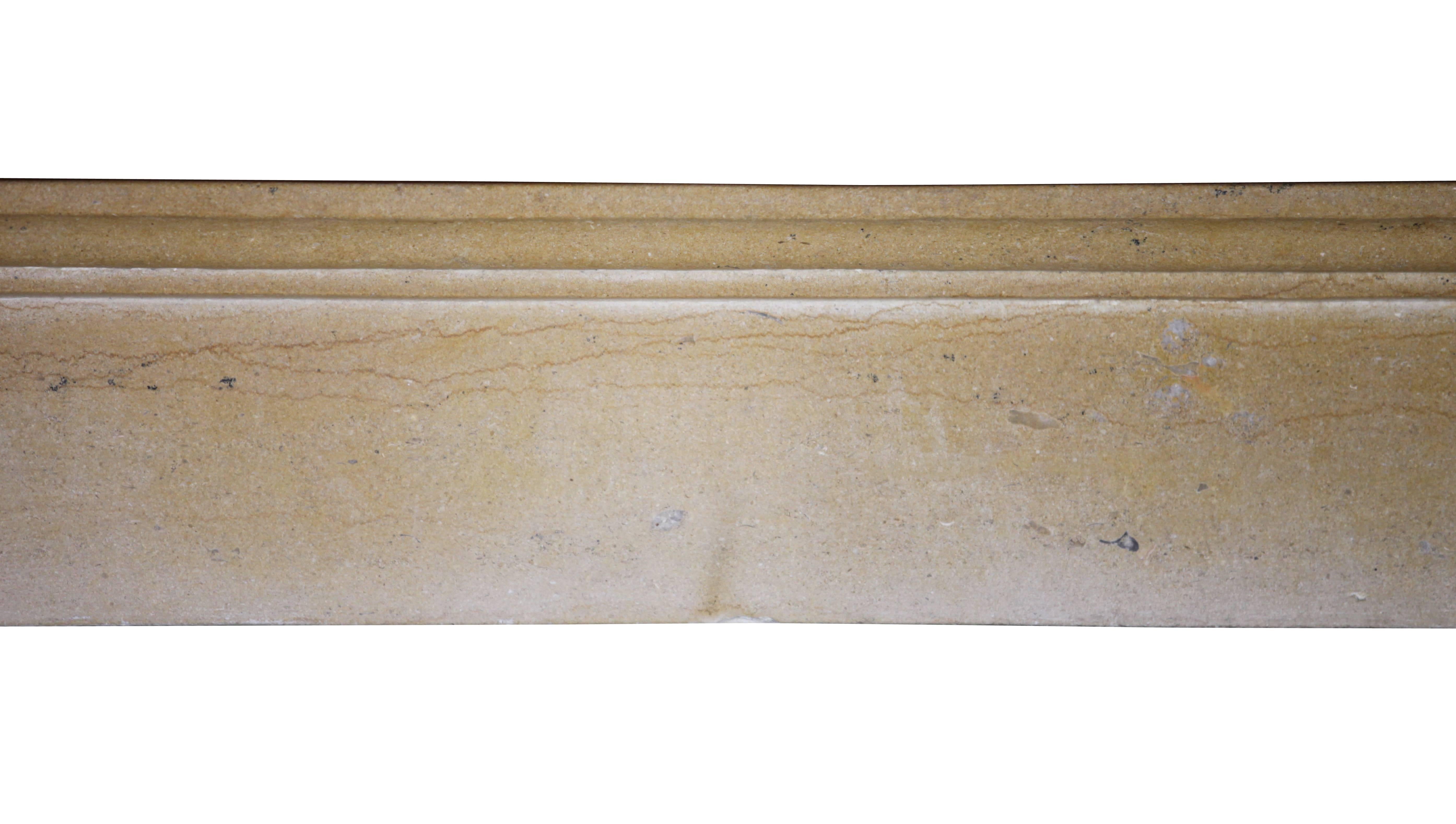 A fine European antique fireplace mantelpiece in a plain waxed limestone. A smooth ancient surface. It was built in the 19th century in the French the Burgundy region. Elegant, classy and not expensive for a timeless chique word interior design