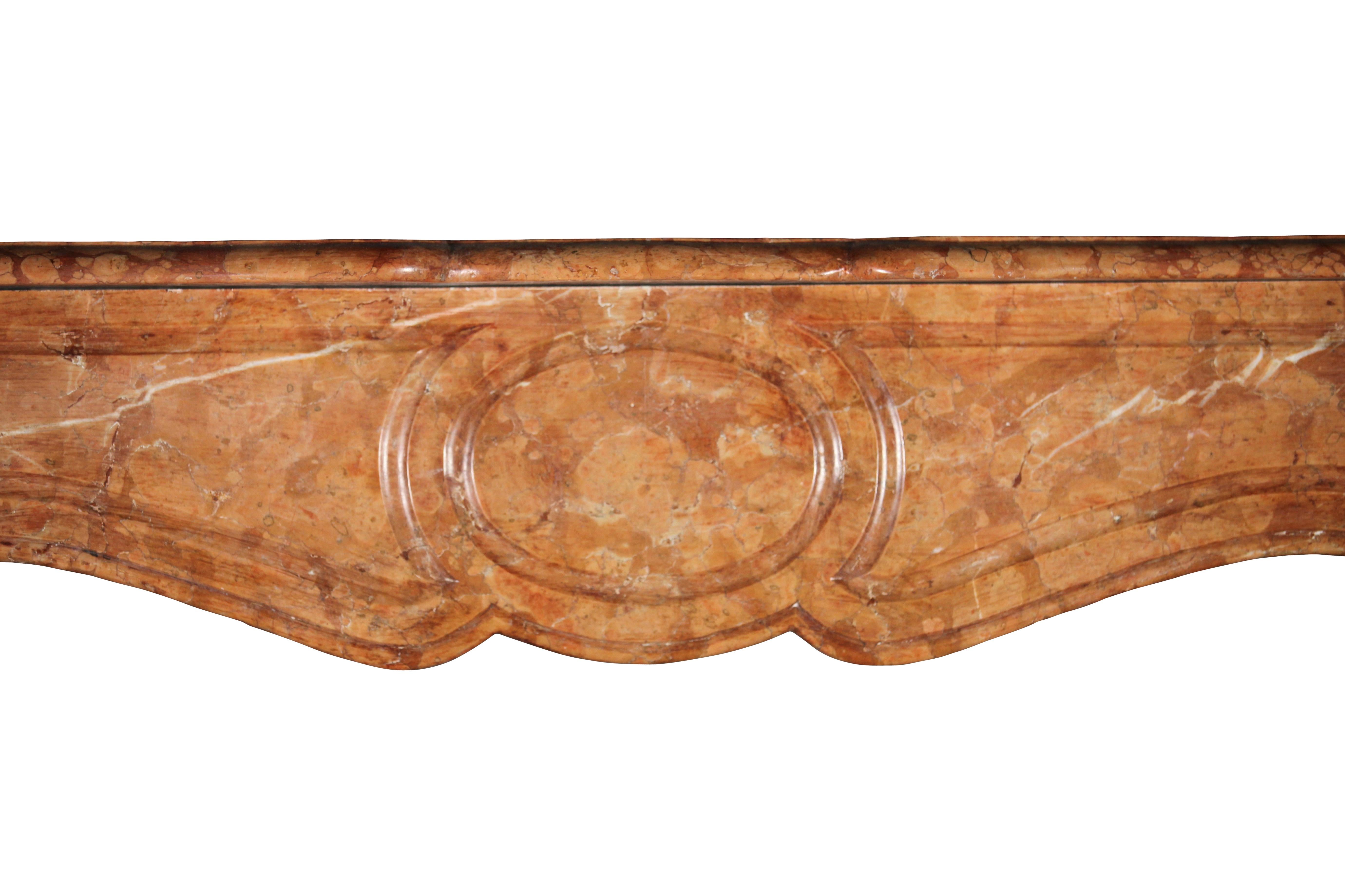 This is a very nice and decorative Pompadour mantel in a great looking marble. This surround had some small restorations, however is now in a perfect condition and ready to be installed. The warm color and small measurements are what it makes it
