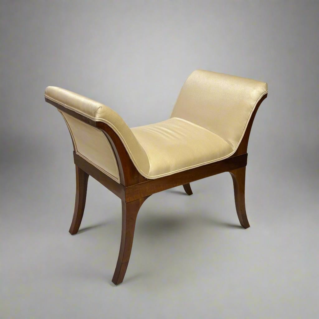 A fine Neoclassical bench in a lyre form. Beautifully finished, exposed walnut frame with tight seat and sides.  Upholstered in creme silk satin. An elegant piece to add seating to any area. Austria, c1820's