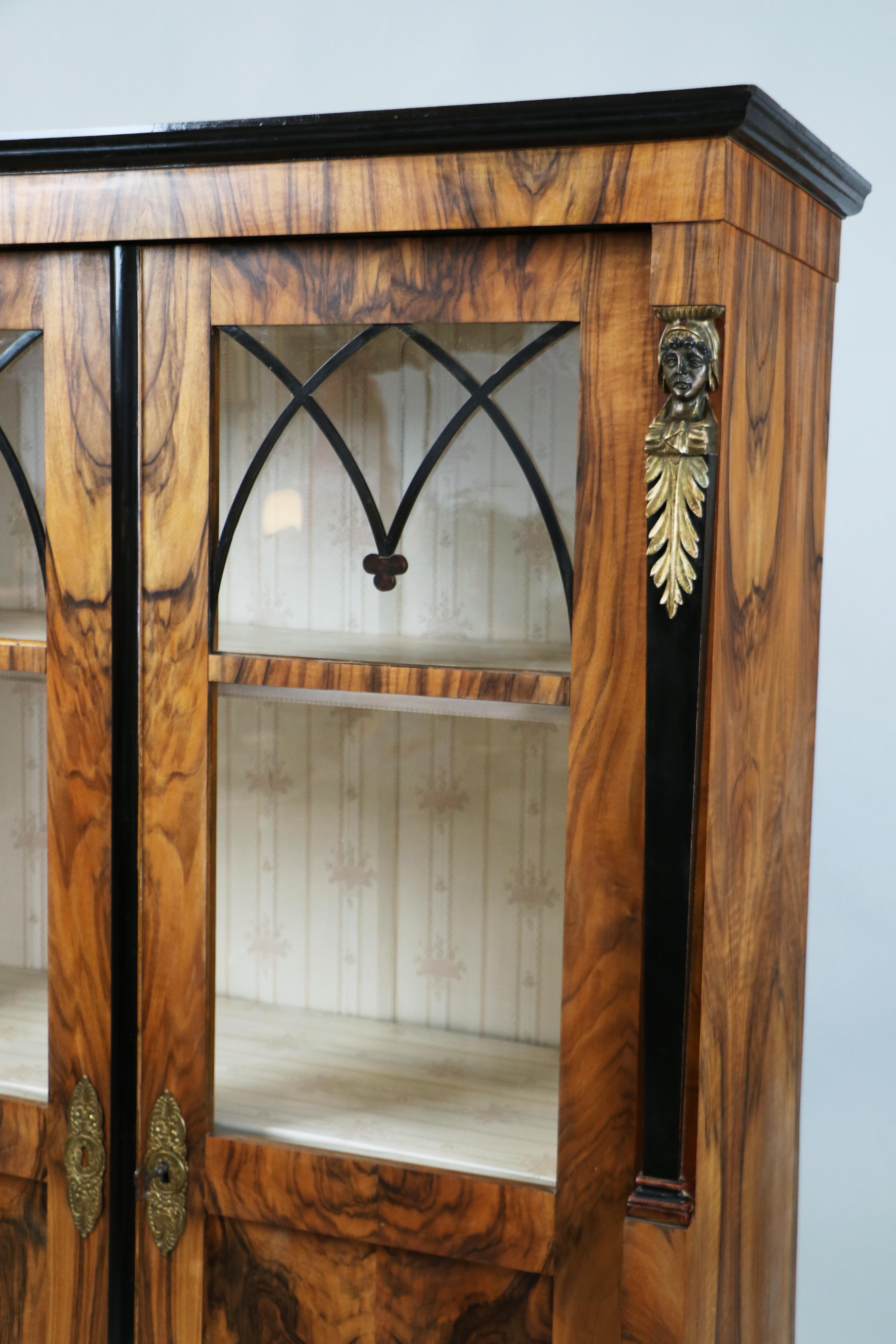 Exceptional Pair of Early Viennese Biedermeier Two-Door Glazed Walnut Vitrines, c. 1825

We are delighted to present this magnificent pair of early Viennese Biedermeier vitrines, crafted in Vienna circa 1825 — true masterpieces of balance,