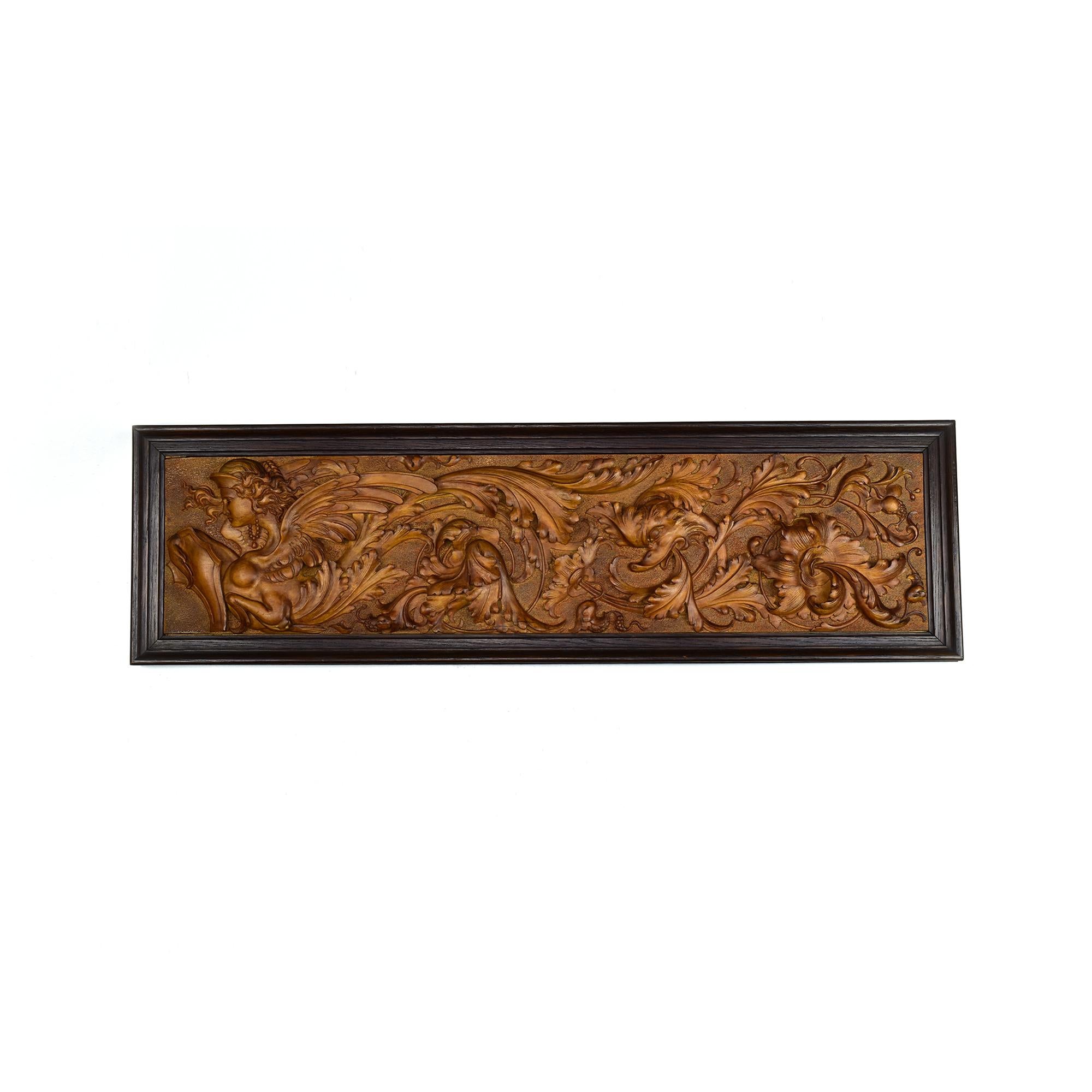 This exceptional masterpiece of the 19th Century showcases remarkable craftsmanship with finest detailing. The carved wooden wall panel shows a composition featuring a central mythological sphinx, beautifully rendered with delicate facial features,