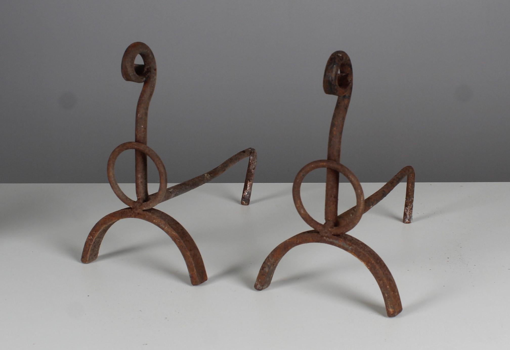 Pair of andirons in a plain design.
France, 1880-1900.
Solid iron in good condition according to its age.

Firedogs are used as a holder for firewood in a fireplace. They are also known as a fire horse, andiron or chimney blocks. It usually consists