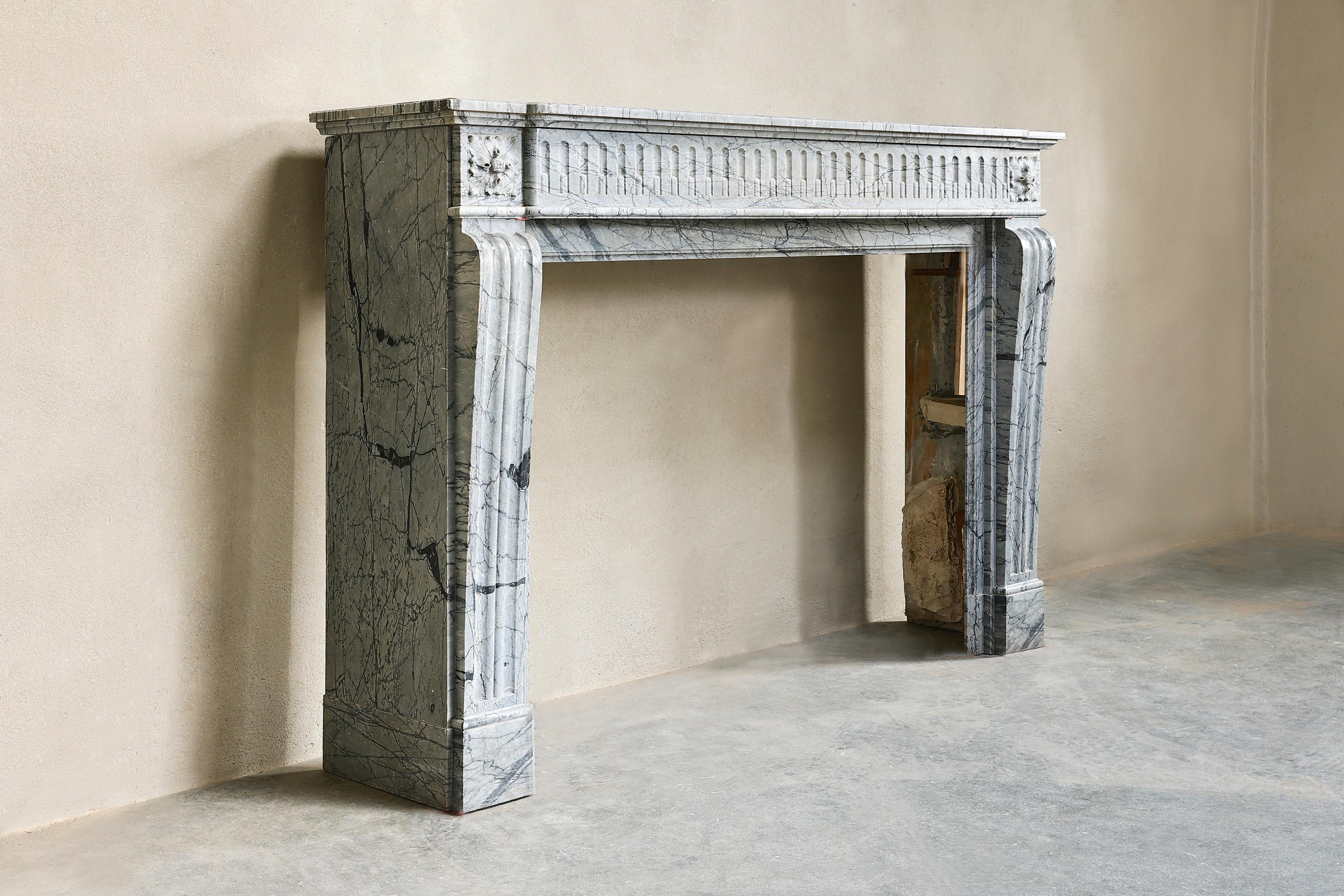A beautiful 19th century Blue Fleuri marble fireplace in the style of Louis XVI. A straight model with many fluting in the front part and continuous on the legs! The dimensions are also perfectly proportioned and fit in with a sleek, modern or new