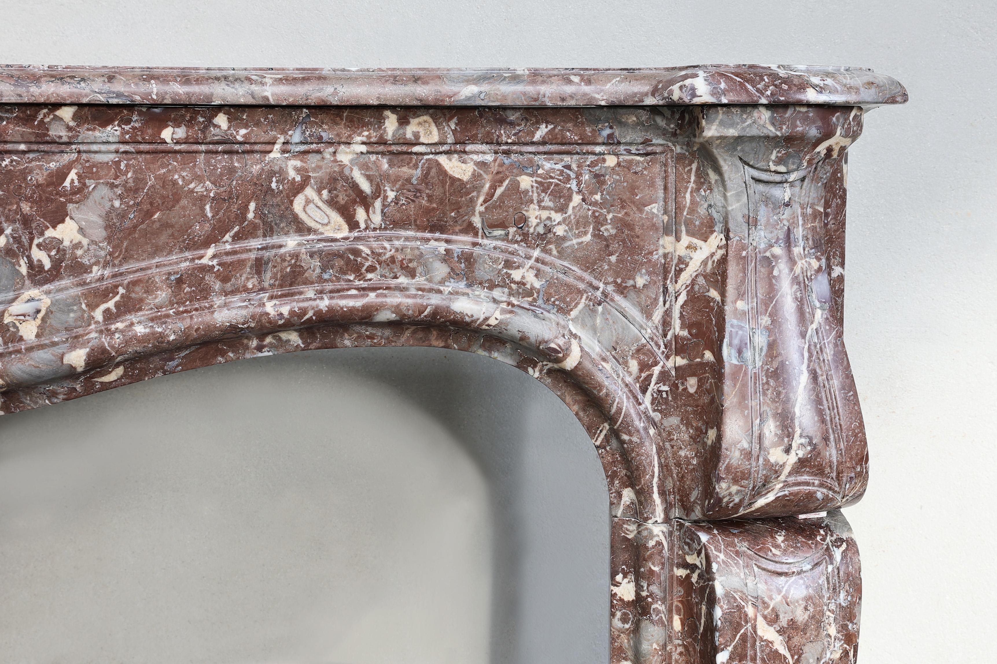 French 19th century fireplace made of Rouge Royal marble in the style of Louis XV  For Sale