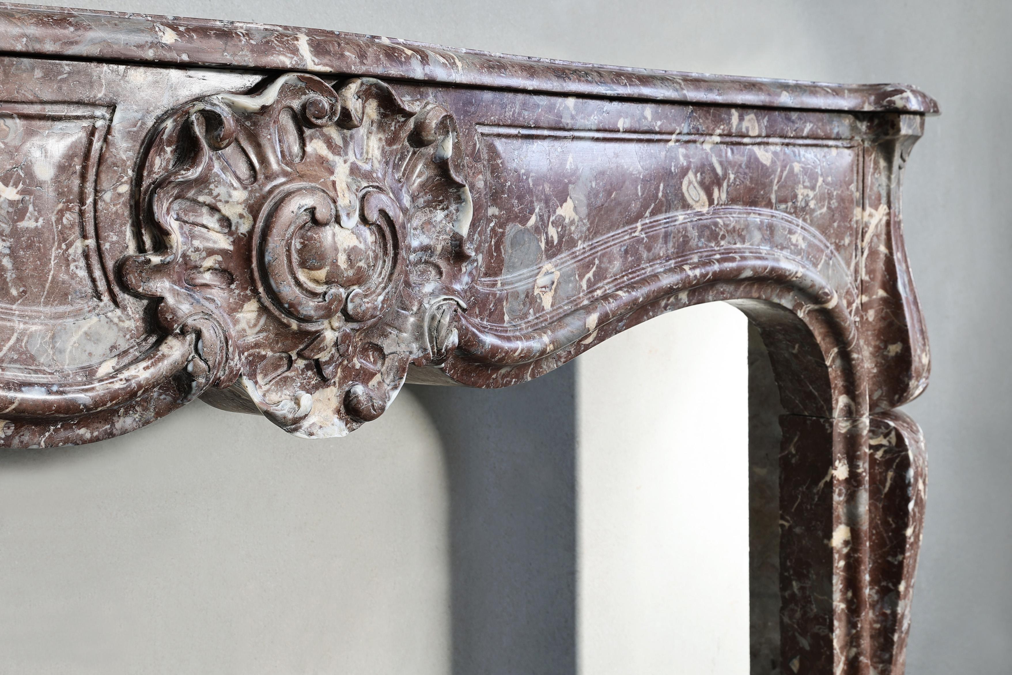 19th century fireplace made of Rouge Royal marble in the style of Louis XV  In Good Condition For Sale In Made, NL
