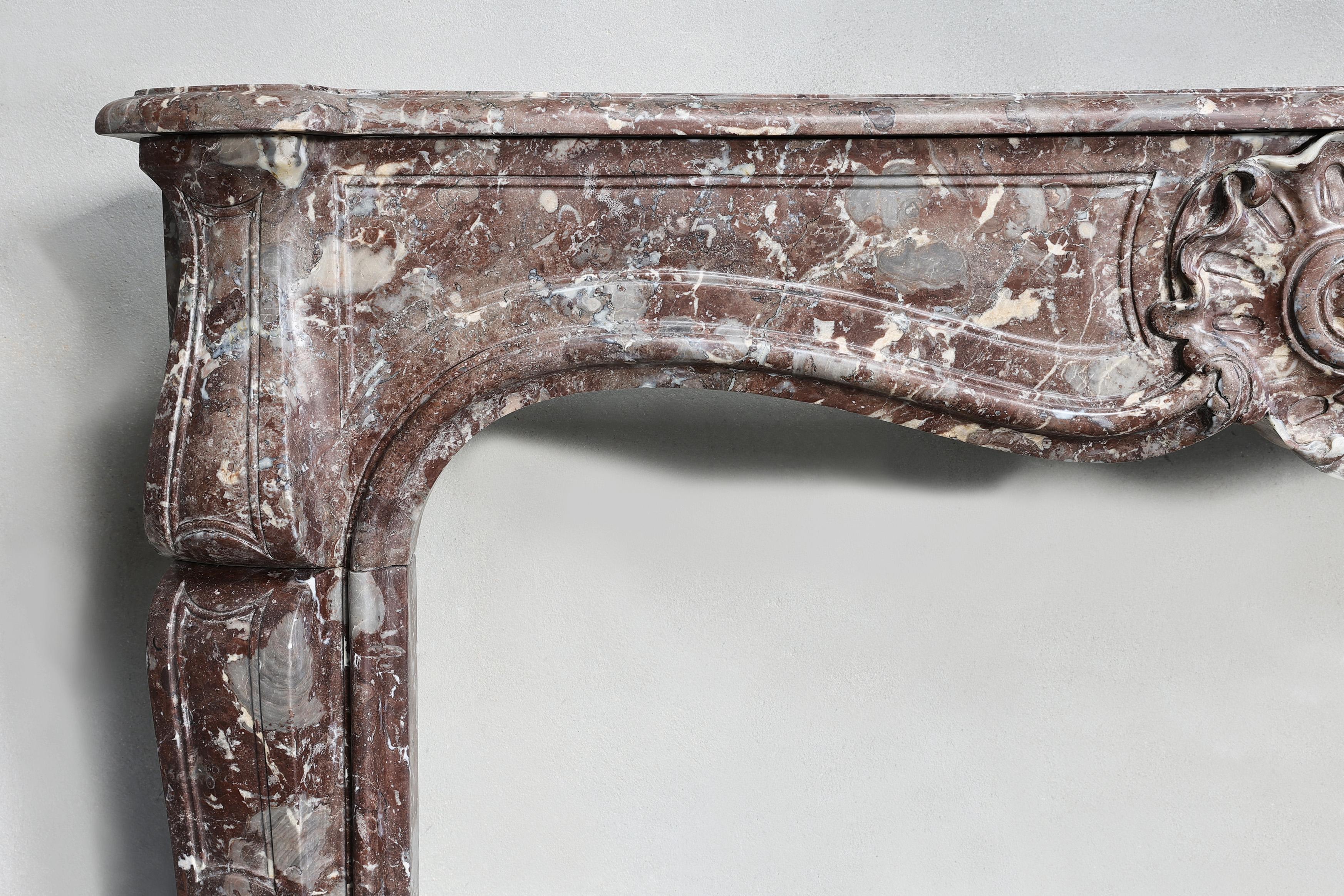 19th Century 19th century fireplace made of Rouge Royal marble in the style of Louis XV  For Sale