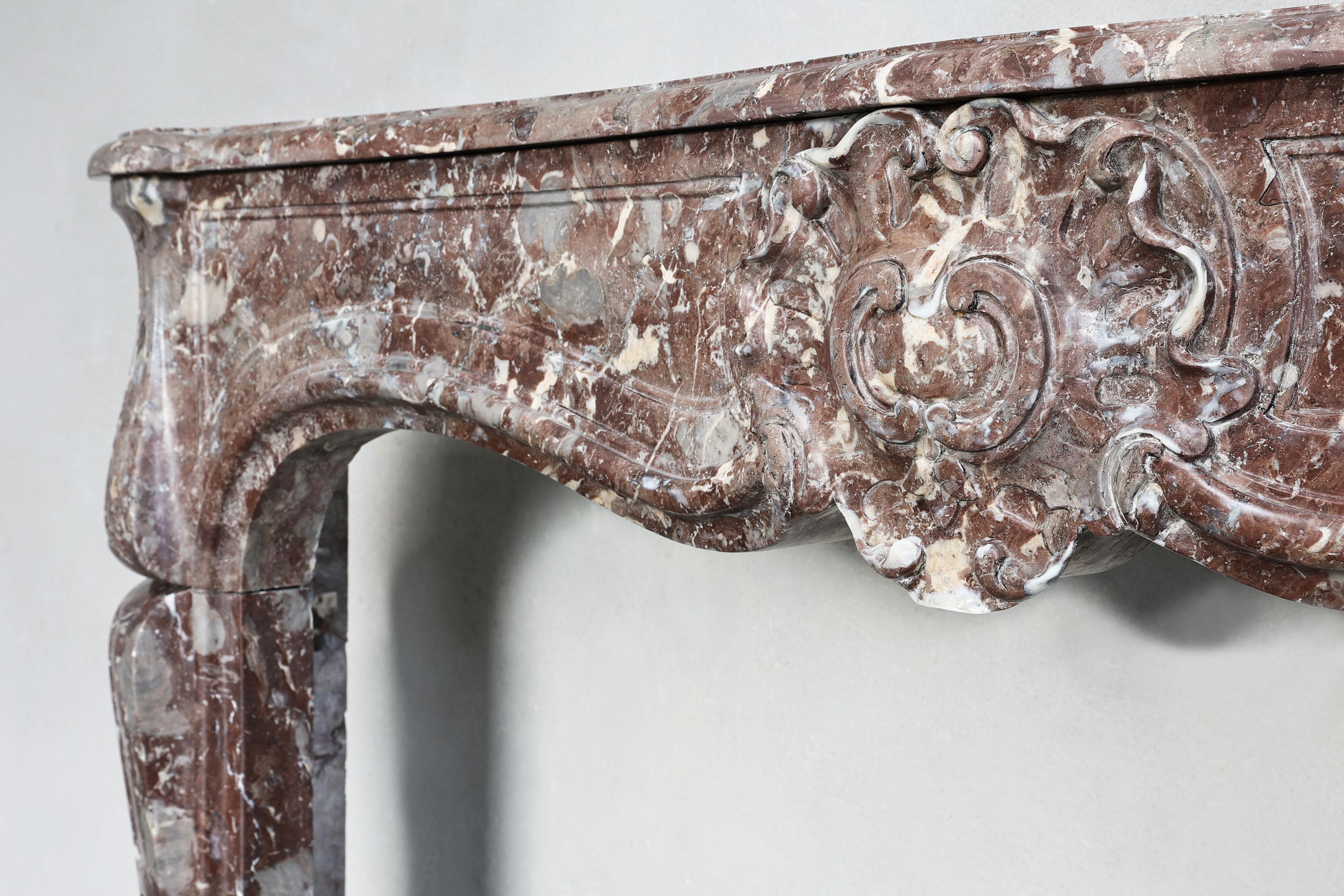 Marble 19th century fireplace made of Rouge Royal marble in the style of Louis XV  For Sale