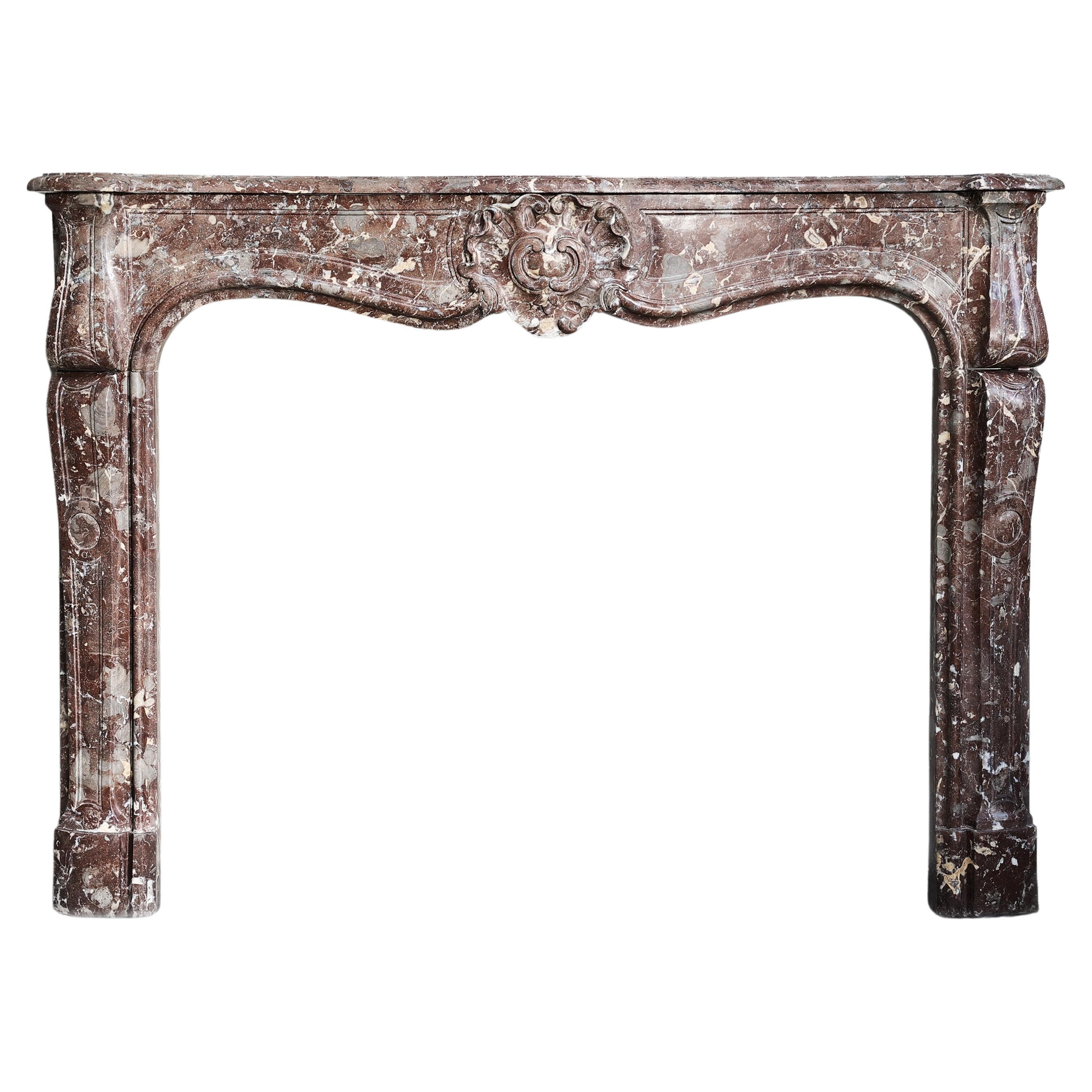 19th century fireplace made of Rouge Royal marble in the style of Louis XV  For Sale