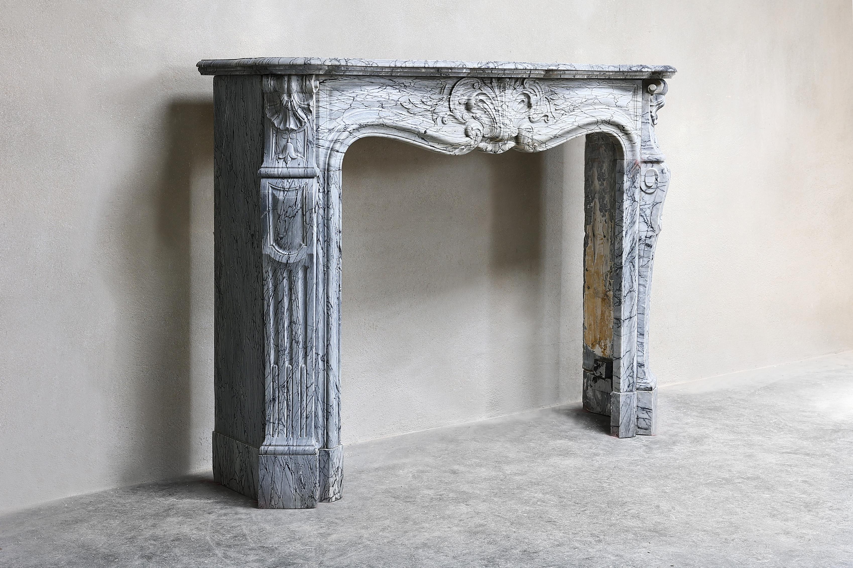 Beautiful compact fireplace of Blue Fleuri marble from the 19th century! This fireplace dates from the 19th century and is in the style of Louis XV with a scallop in the middle and on both sides. We got this fireplace from an apartment in Paris.