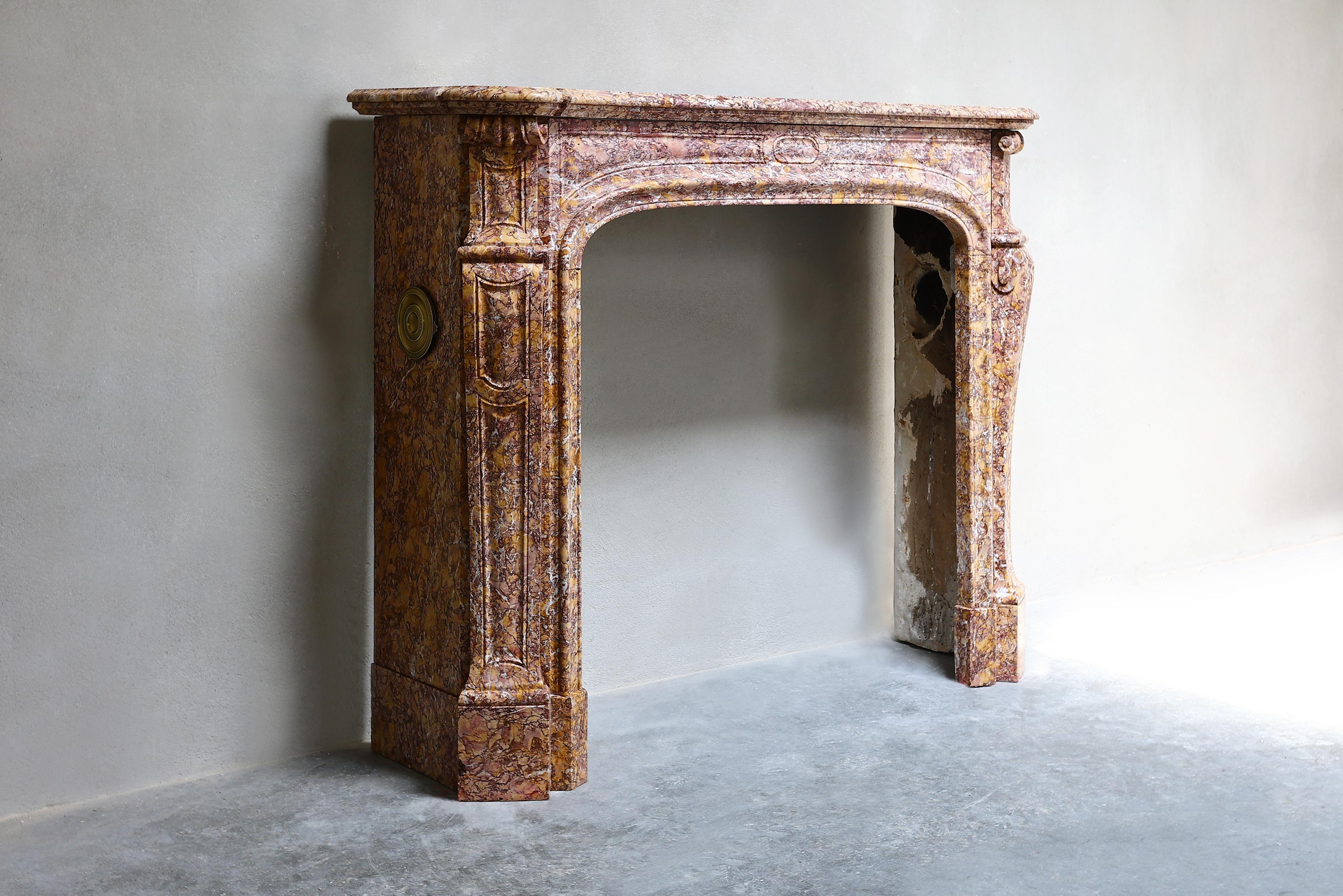 Special antique fireplace of the colorful marble type 'Brocatelle Violetta du Jura'. As the name suggests, this fireplace comes from the Jura, a beautiful region in France! This fireplace dates from the 19th century and is in the style of Louis XIV.