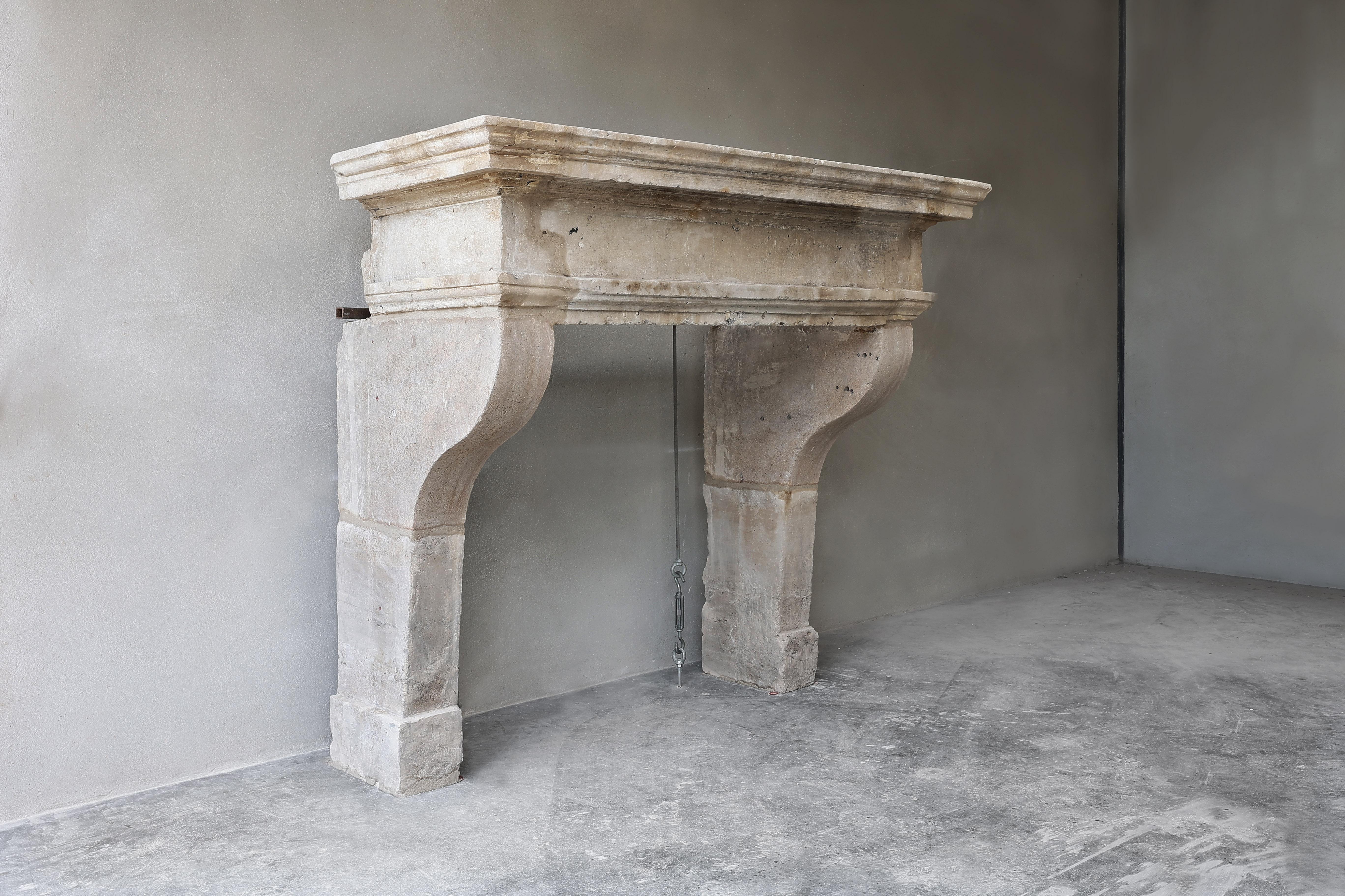 Antique stately fireplace from the 19th century made of French limestone! This Campagnarde-style fireplace has a beautiful wide top with robust lines. This fireplace has a beautiful color scheme and the dimensions are also suitable for many